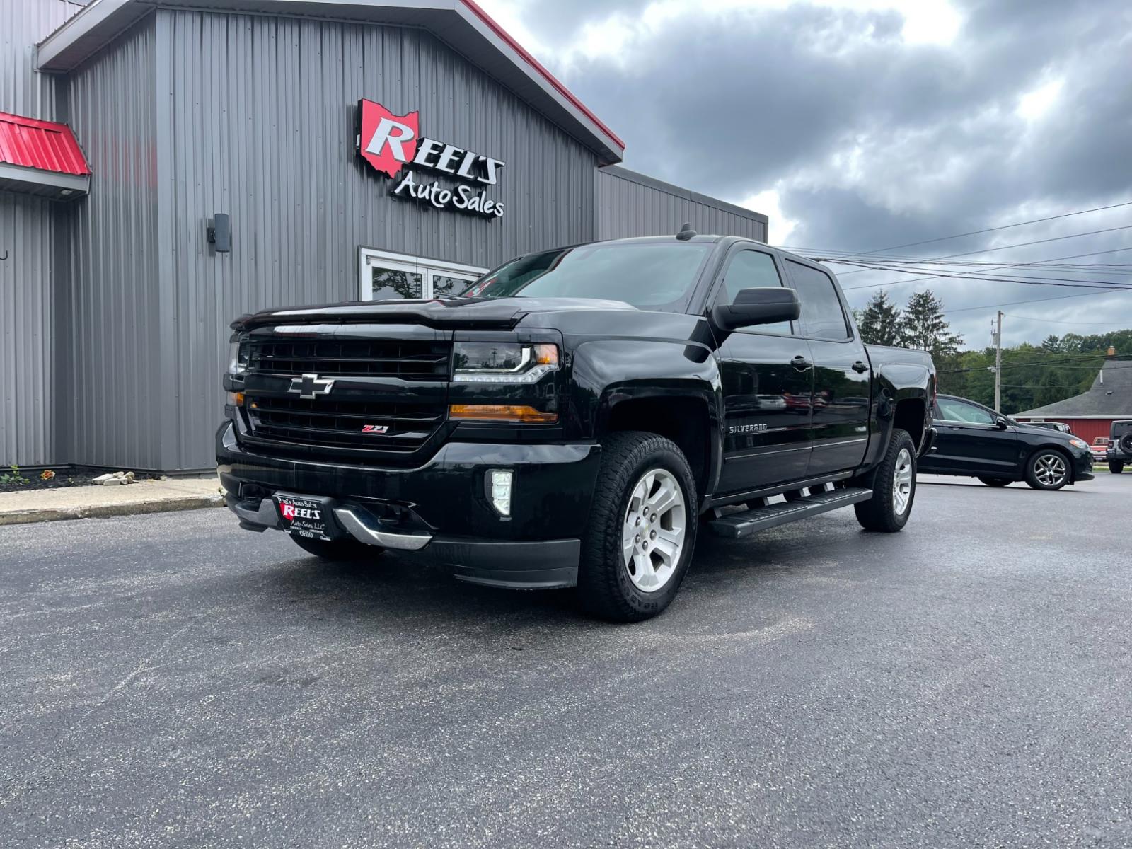 2018 Black /Black Chevrolet Silverado 1500 2LT Crew Cab 4WD (3GCUKREC9JG) with an 5.3L V8 OHV 16V engine, 6A transmission, located at 11115 Chardon Rd. , Chardon, OH, 44024, (440) 214-9705, 41.580246, -81.241943 - The 2018 Chevrolet Silverado 2LT Crew Cab Z71 5.3 comes with a powerful 5.3-liter V8 engine that generates 355 horsepower and 383 lb-ft of torque. It has a towing capacity of up to 9,100 pounds and can go from 0 to 60 mph in 6.7 seconds. The Z71 package includes off-road suspension, skid plates, and - Photo #0