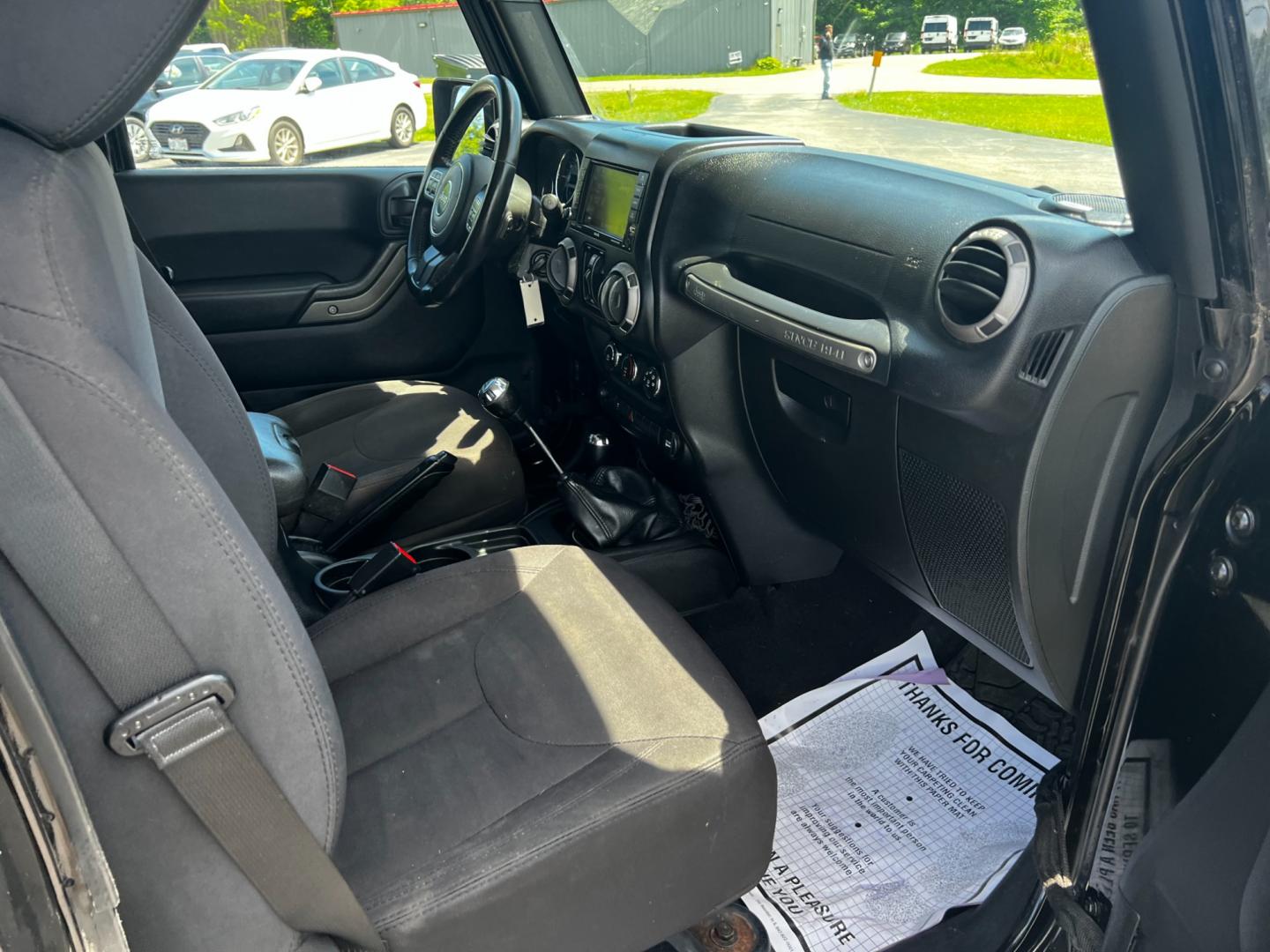 2015 Black /Black Jeep Wrangler Unlimited Willys 4WD (1C4BJWDG9FL) with an 3.6L V6 DOHC 24V engine, 6 Speed Manual transmission, located at 11115 Chardon Rd. , Chardon, OH, 44024, (440) 214-9705, 41.580246, -81.241943 - This 2015 Jeep Wrangler Unlimited Willy Wheeler Edition is a capable and well-equipped off-road vehicle. It features a 3.6-liter Pentastar V6 engine paired with a 6-speed manual transmission, offering a traditional driving experience favored by many off-road enthusiasts. The vehicle comes with sever - Photo#33