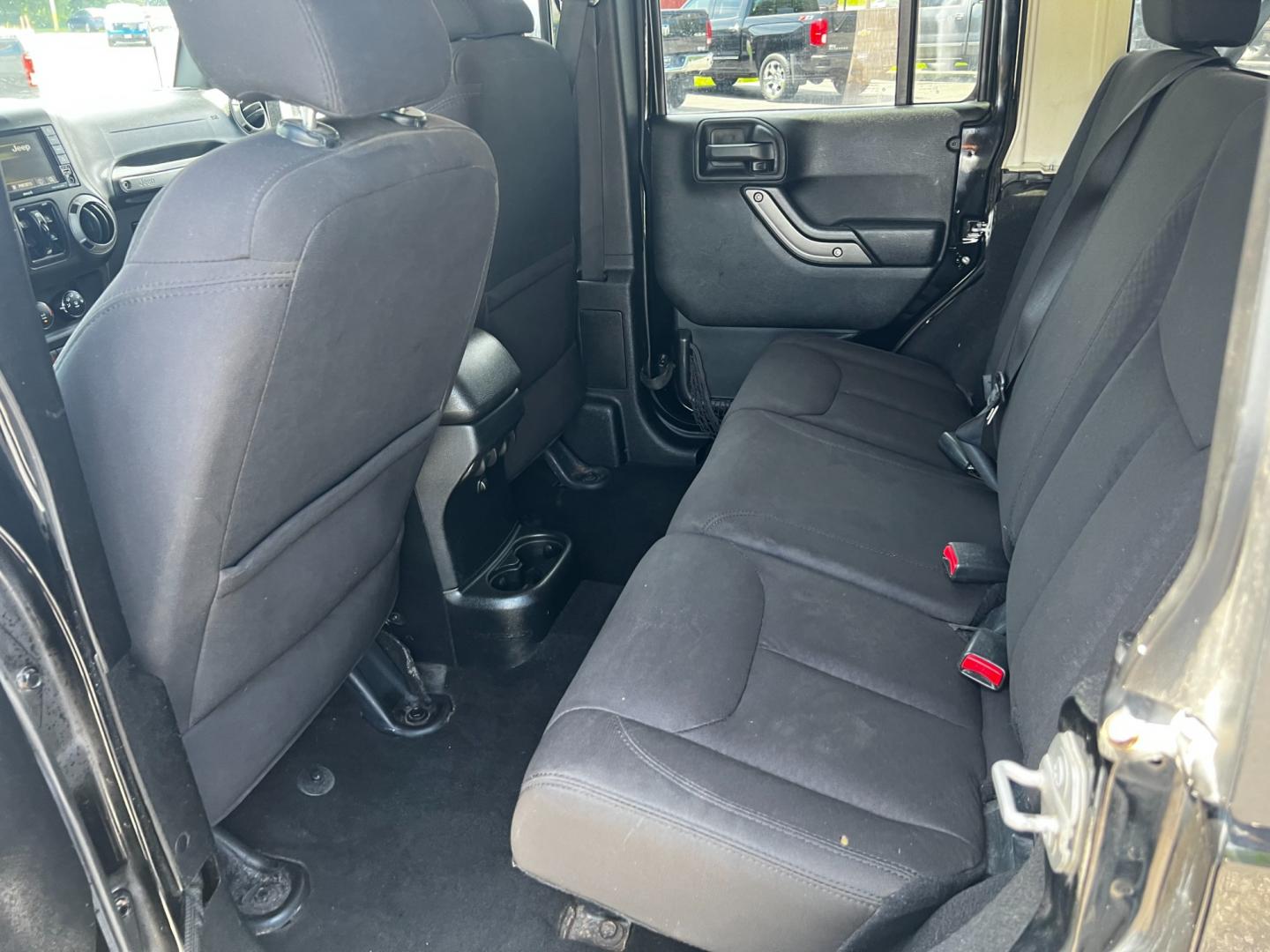 2015 Black /Black Jeep Wrangler Unlimited Willys 4WD (1C4BJWDG9FL) with an 3.6L V6 DOHC 24V engine, 6 Speed Manual transmission, located at 11115 Chardon Rd. , Chardon, OH, 44024, (440) 214-9705, 41.580246, -81.241943 - This 2015 Jeep Wrangler Unlimited Willy Wheeler Edition is a capable and well-equipped off-road vehicle. It features a 3.6-liter Pentastar V6 engine paired with a 6-speed manual transmission, offering a traditional driving experience favored by many off-road enthusiasts. The vehicle comes with sever - Photo#26