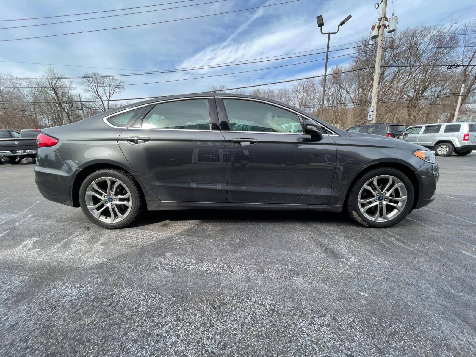 2019 Gray /Black Ford Fusion SEL (3FA6P0CD5KR) with an 1.5L I4 DOHC 16V TURBO engine, 6A transmission, located at 11115 Chardon Rd. , Chardon, OH, 44024, (440) 214-9705, 41.580246, -81.241943 - Photo #5