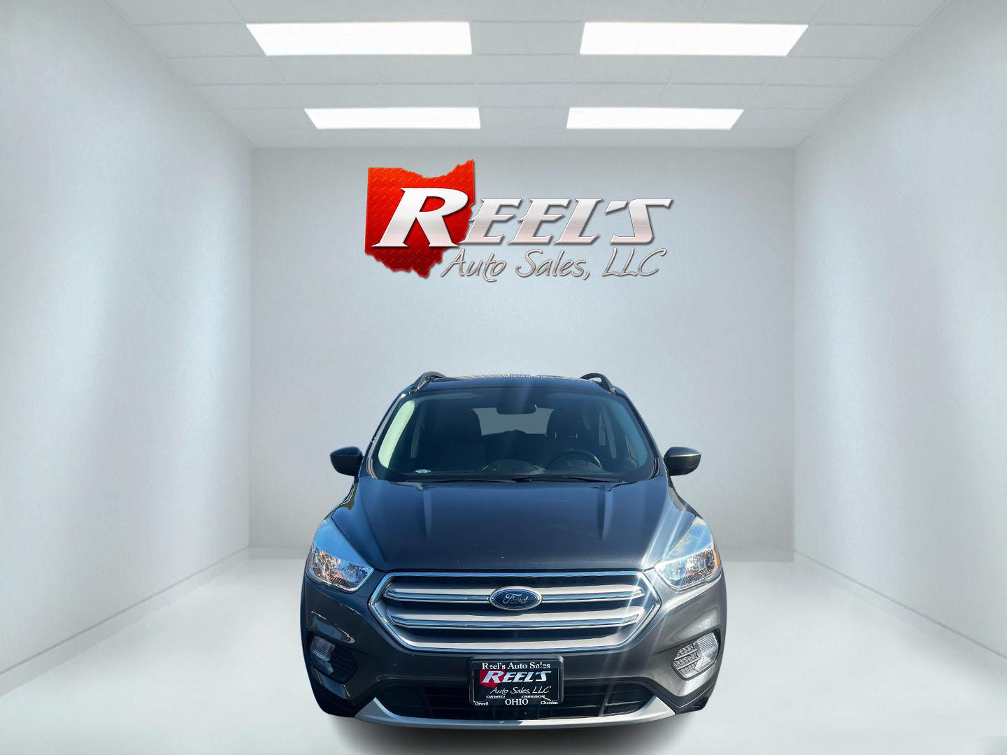 2018 Gray /Black Ford Escape SE 4WD (1FMCU9GD0JU) with an 1.5L I4 DOHC 16V TURBO engine, 6 Speed Auto transmission, located at 547 E. Main St., Orwell, OH, 44076, (440) 437-5893, 41.535435, -80.847855 - This 2018 Ford Escape SE 4WD is a compact SUV designed for efficiency and comfort, powered by a 1.5-liter turbocharged I4 EcoBoost engine, paired with a 6-speed automatic transmission, achieving an impressive 28 MPG on the highway. This Escape incorporates Auto Start Stop technology to enhance fuel - Photo#1