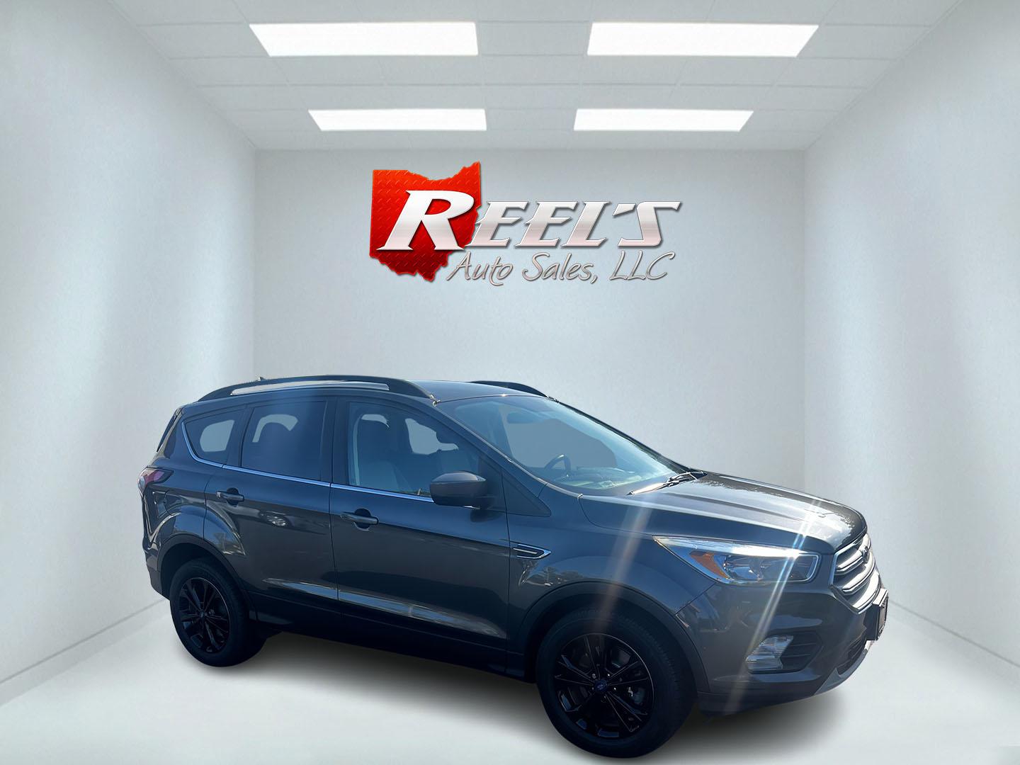 2018 Gray /Black Ford Escape SE 4WD (1FMCU9GD0JU) with an 1.5L I4 DOHC 16V TURBO engine, 6 Speed Auto transmission, located at 547 E. Main St., Orwell, OH, 44076, (440) 437-5893, 41.535435, -80.847855 - This 2018 Ford Escape SE 4WD is a compact SUV designed for efficiency and comfort, powered by a 1.5-liter turbocharged I4 EcoBoost engine, paired with a 6-speed automatic transmission, achieving an impressive 28 MPG on the highway. This Escape incorporates Auto Start Stop technology to enhance fuel - Photo#3