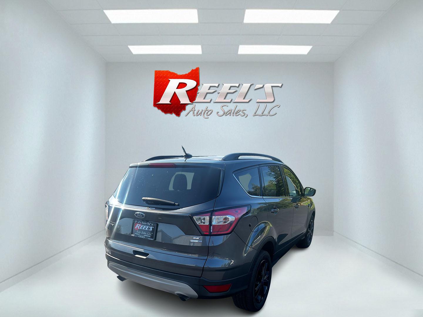 2018 Gray /Black Ford Escape SE 4WD (1FMCU9GD0JU) with an 1.5L I4 DOHC 16V TURBO engine, 6 Speed Auto transmission, located at 547 E. Main St., Orwell, OH, 44076, (440) 437-5893, 41.535435, -80.847855 - This 2018 Ford Escape SE 4WD is a compact SUV designed for efficiency and comfort, powered by a 1.5-liter turbocharged I4 EcoBoost engine, paired with a 6-speed automatic transmission, achieving an impressive 28 MPG on the highway. This Escape incorporates Auto Start Stop technology to enhance fuel - Photo#5