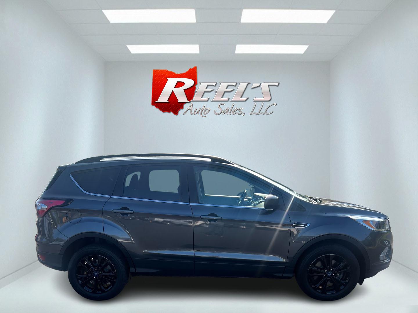 2018 Gray /Black Ford Escape SE 4WD (1FMCU9GD0JU) with an 1.5L I4 DOHC 16V TURBO engine, 6 Speed Auto transmission, located at 547 E. Main St., Orwell, OH, 44076, (440) 437-5893, 41.535435, -80.847855 - This 2018 Ford Escape SE 4WD is a compact SUV designed for efficiency and comfort, powered by a 1.5-liter turbocharged I4 EcoBoost engine, paired with a 6-speed automatic transmission, achieving an impressive 28 MPG on the highway. This Escape incorporates Auto Start Stop technology to enhance fuel - Photo#4