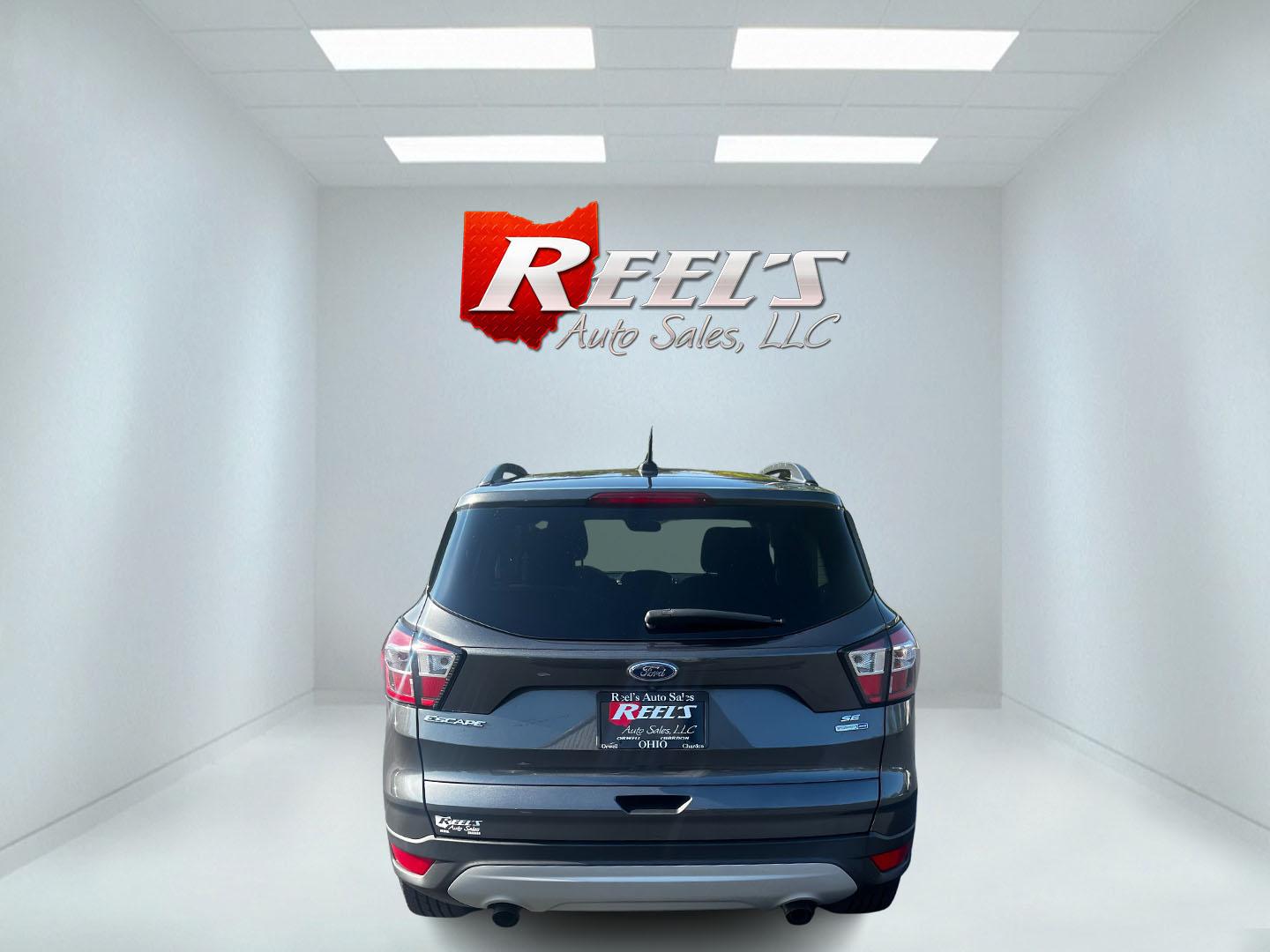 2018 Gray /Black Ford Escape SE 4WD (1FMCU9GD0JU) with an 1.5L I4 DOHC 16V TURBO engine, 6 Speed Auto transmission, located at 547 E. Main St., Orwell, OH, 44076, (440) 437-5893, 41.535435, -80.847855 - This 2018 Ford Escape SE 4WD is a compact SUV designed for efficiency and comfort, powered by a 1.5-liter turbocharged I4 EcoBoost engine, paired with a 6-speed automatic transmission, achieving an impressive 28 MPG on the highway. This Escape incorporates Auto Start Stop technology to enhance fuel - Photo#6
