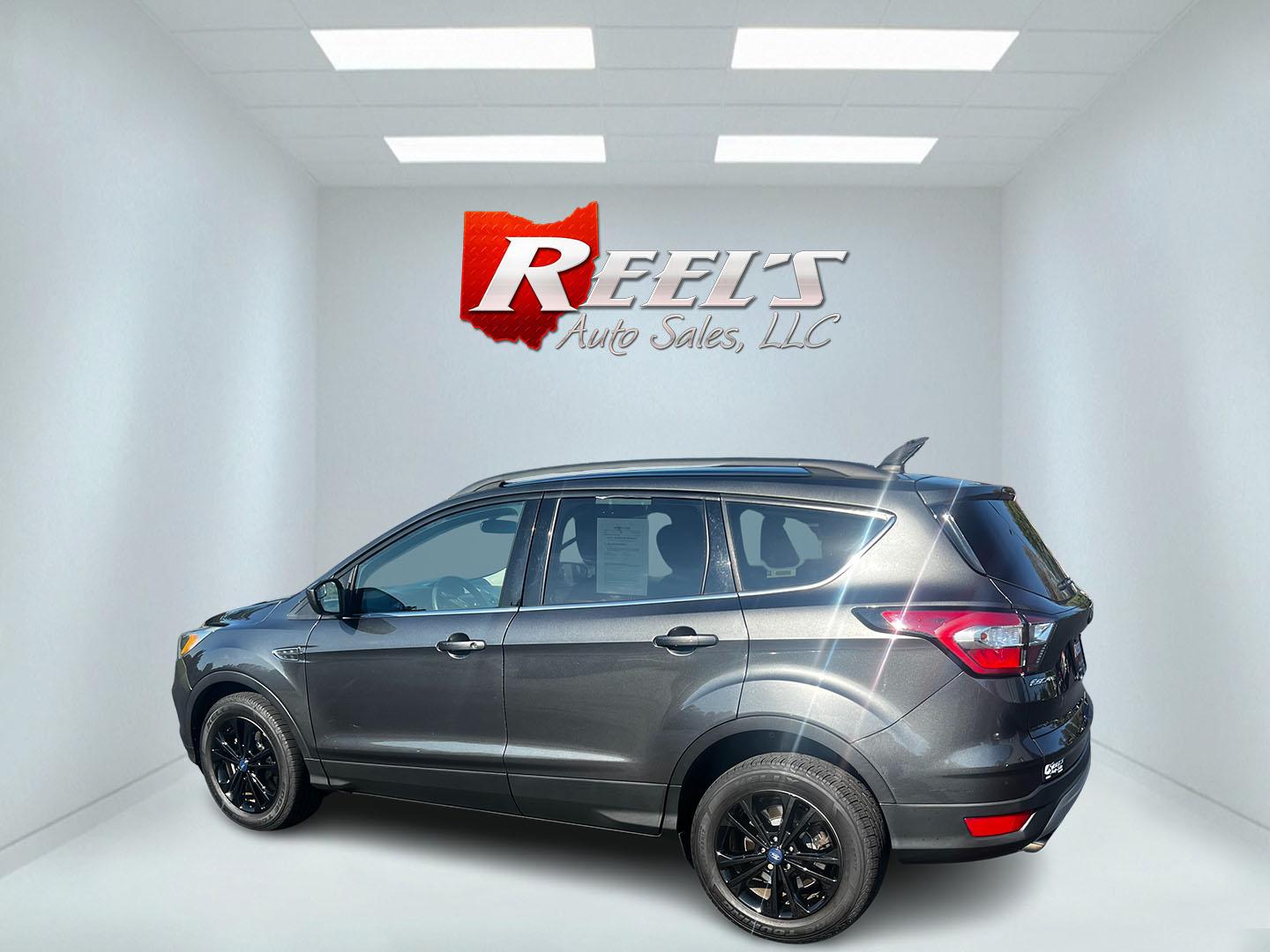 2018 Gray /Black Ford Escape SE 4WD (1FMCU9GD0JU) with an 1.5L I4 DOHC 16V TURBO engine, 6 Speed Auto transmission, located at 547 E. Main St., Orwell, OH, 44076, (440) 437-5893, 41.535435, -80.847855 - This 2018 Ford Escape SE 4WD is a compact SUV designed for efficiency and comfort, powered by a 1.5-liter turbocharged I4 EcoBoost engine, paired with a 6-speed automatic transmission, achieving an impressive 28 MPG on the highway. This Escape incorporates Auto Start Stop technology to enhance fuel - Photo#8