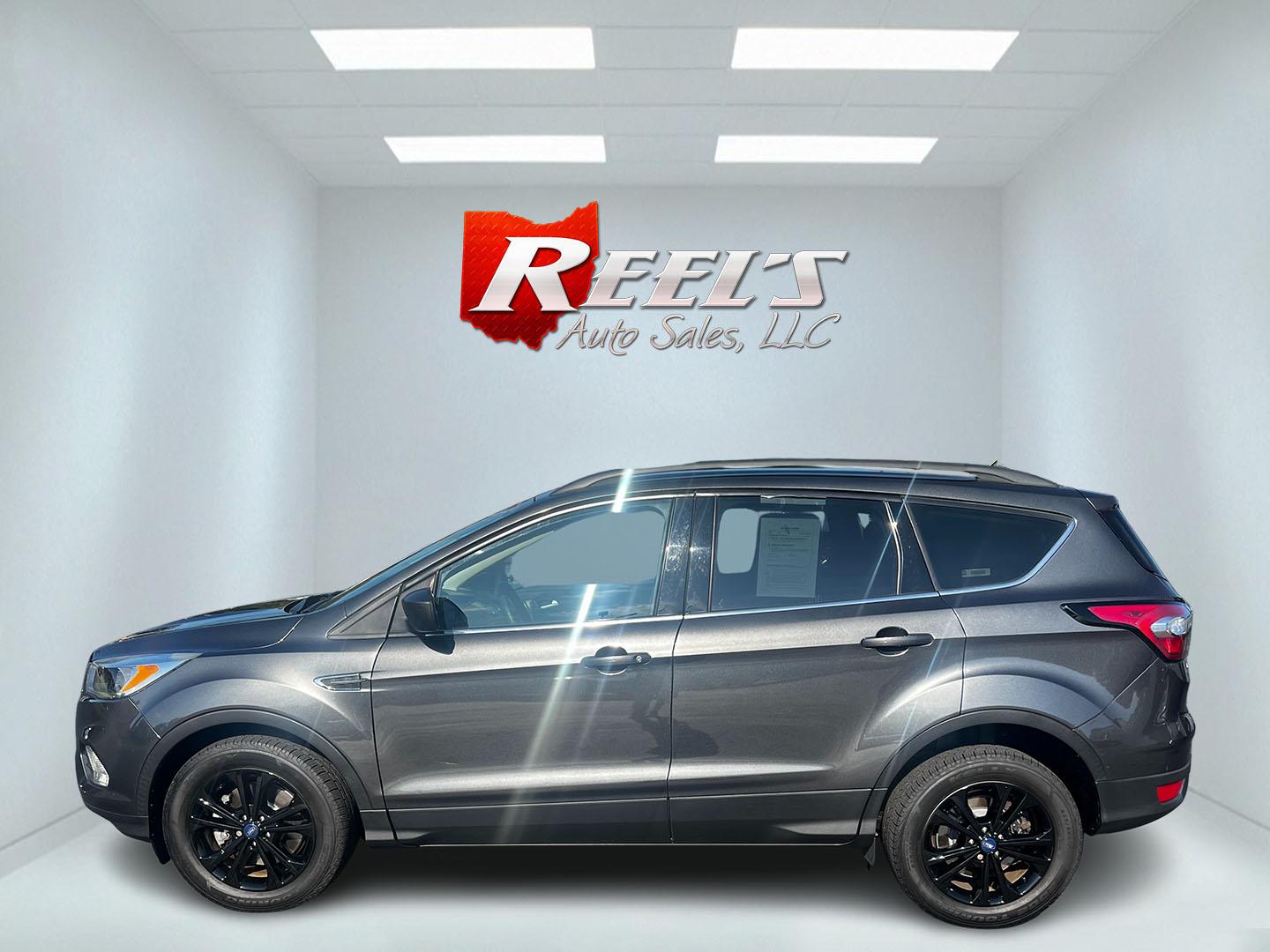 2018 Gray /Black Ford Escape SE 4WD (1FMCU9GD0JU) with an 1.5L I4 DOHC 16V TURBO engine, 6 Speed Auto transmission, located at 547 E. Main St., Orwell, OH, 44076, (440) 437-5893, 41.535435, -80.847855 - This 2018 Ford Escape SE 4WD is a compact SUV designed for efficiency and comfort, powered by a 1.5-liter turbocharged I4 EcoBoost engine, paired with a 6-speed automatic transmission, achieving an impressive 28 MPG on the highway. This Escape incorporates Auto Start Stop technology to enhance fuel - Photo#9