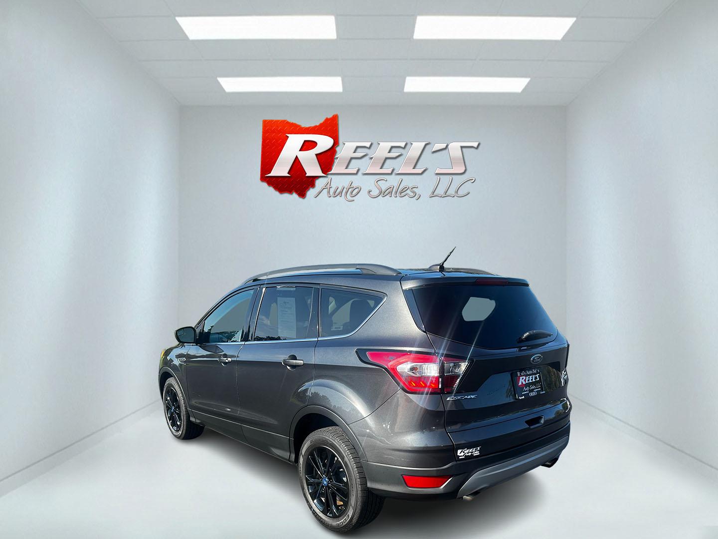 2018 Gray /Black Ford Escape SE 4WD (1FMCU9GD0JU) with an 1.5L I4 DOHC 16V TURBO engine, 6 Speed Auto transmission, located at 547 E. Main St., Orwell, OH, 44076, (440) 437-5893, 41.535435, -80.847855 - This 2018 Ford Escape SE 4WD is a compact SUV designed for efficiency and comfort, powered by a 1.5-liter turbocharged I4 EcoBoost engine, paired with a 6-speed automatic transmission, achieving an impressive 28 MPG on the highway. This Escape incorporates Auto Start Stop technology to enhance fuel - Photo#7