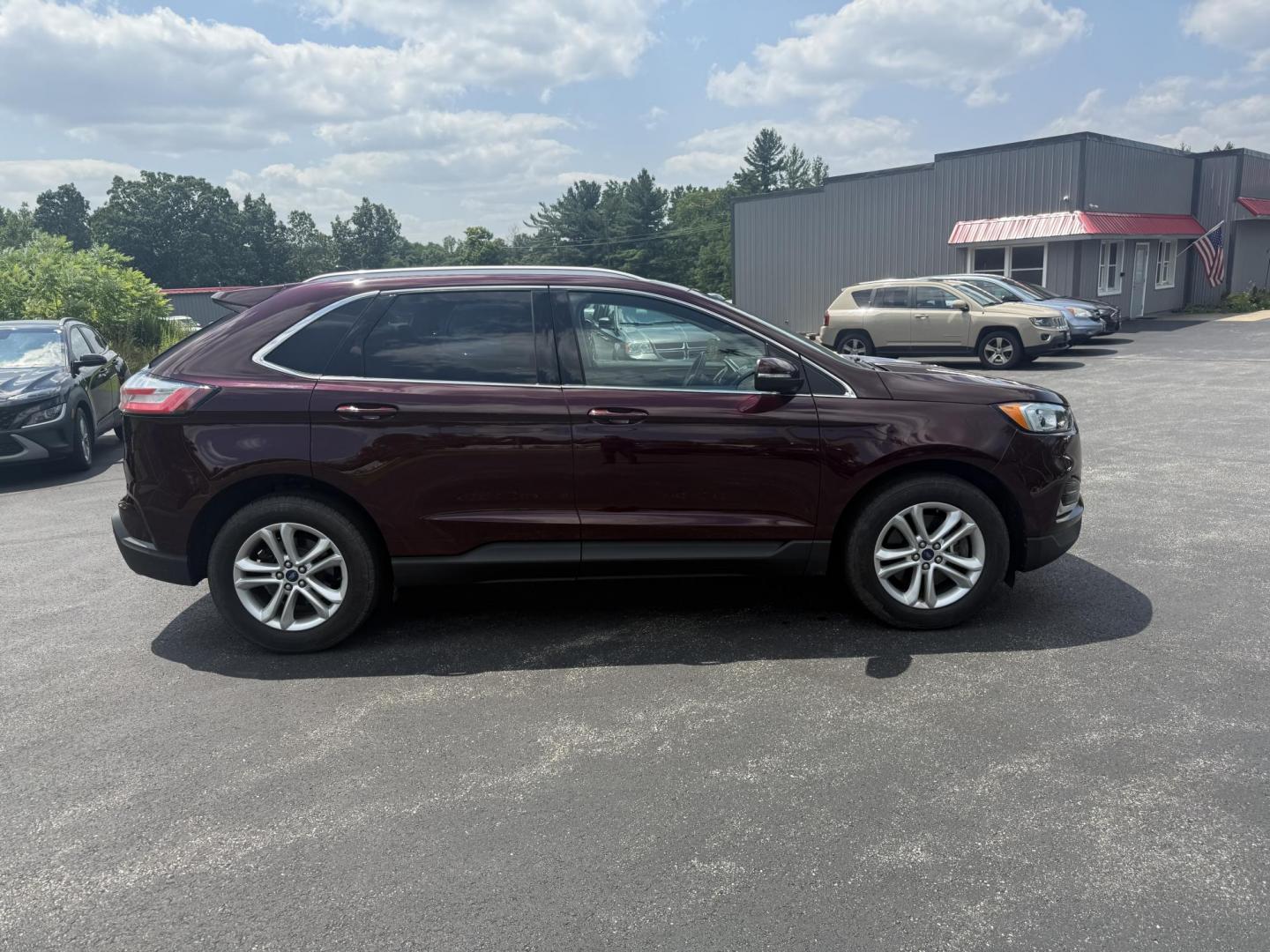 2019 Burgundy /Black Ford Edge SEL AWD (2FMPK4J96KB) with an 2.0L I4 DOHC 16V Turbo engine, 8-Speed Automatic transmission, located at 11115 Chardon Rd. , Chardon, OH, 44024, (440) 214-9705, 41.580246, -81.241943 - FRESH TRADE ALET ----- 2019 Ford Edge SEL AWD is a sophisticated midsize SUV combining performance, technology, and comfort. It features a 2.0-liter turbocharged I4 EcoBoost engine with a 8-speed automatic transmission, providing a balanced driving experience with efficiency and power. The interior - Photo#5