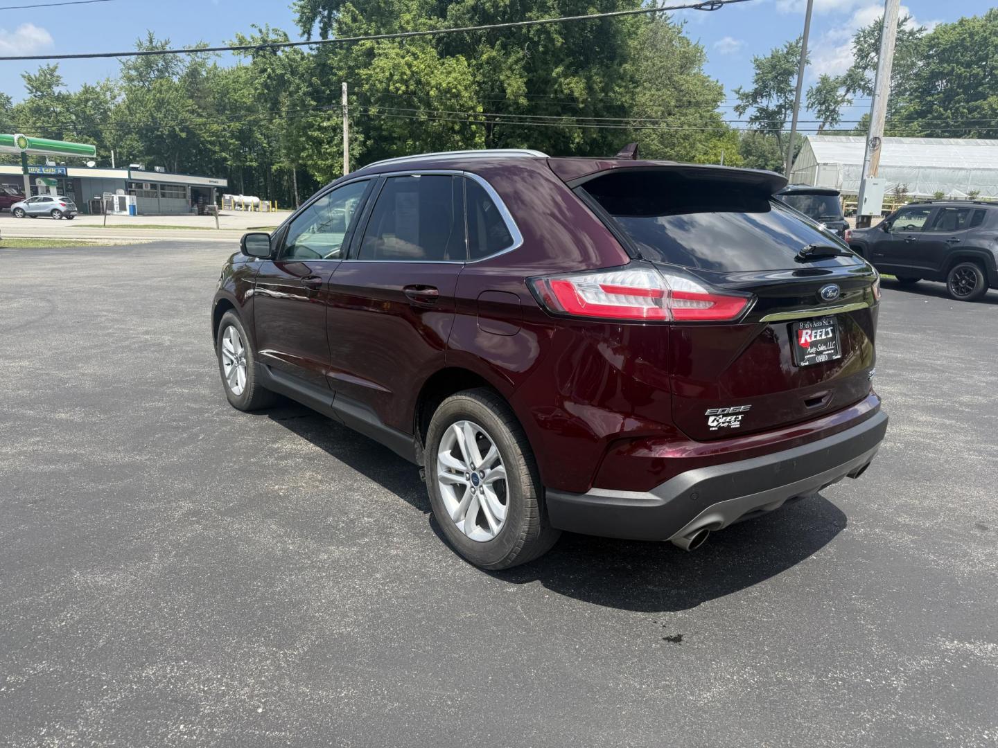 2019 Burgundy /Black Ford Edge SEL AWD (2FMPK4J96KB) with an 2.0L I4 DOHC 16V Turbo engine, 8-Speed Automatic transmission, located at 11115 Chardon Rd. , Chardon, OH, 44024, (440) 214-9705, 41.580246, -81.241943 - FRESH TRADE ALET ----- 2019 Ford Edge SEL AWD is a sophisticated midsize SUV combining performance, technology, and comfort. It features a 2.0-liter turbocharged I4 EcoBoost engine with a 8-speed automatic transmission, providing a balanced driving experience with efficiency and power. The interior - Photo#9