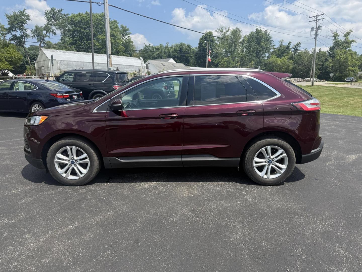 2019 Burgundy /Black Ford Edge SEL AWD (2FMPK4J96KB) with an 2.0L I4 DOHC 16V Turbo engine, 8-Speed Automatic transmission, located at 11115 Chardon Rd. , Chardon, OH, 44024, (440) 214-9705, 41.580246, -81.241943 - FRESH TRADE ALET ----- 2019 Ford Edge SEL AWD is a sophisticated midsize SUV combining performance, technology, and comfort. It features a 2.0-liter turbocharged I4 EcoBoost engine with a 8-speed automatic transmission, providing a balanced driving experience with efficiency and power. The interior - Photo#12