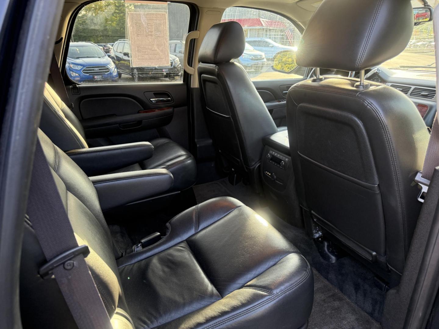 2013 Black /Black Chevrolet Tahoe LTZ 4WD (1GNSKCE02DR) with an 5.3L V8 OHV 16V FFV engine, 6-Speed Automatic transmission, located at 11115 Chardon Rd. , Chardon, OH, 44024, (440) 214-9705, 41.580246, -81.241943 - This 2013 Chevrolet Tahoe LTZ 4WD is a full-size SUV equipped with a 5.3-liter Vortec V8 engine and a 6-speed automatic transmission, as well as 3.42 gearing, which contributes to its impressive 8,200-pound towing capacity. Its interior is designed with luxury and comfort in mind, featuring leather - Photo#40