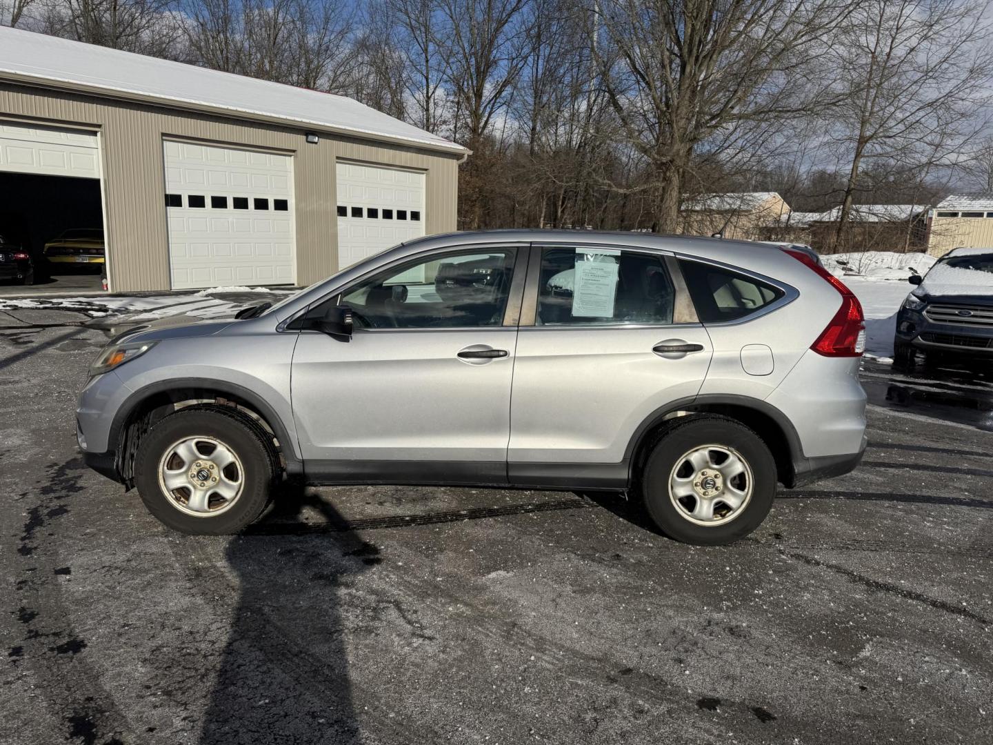 2015 Silver /Gray Honda CR-V LX 4WD (5J6RM4H39FL) with an 2.4L I4 DOHC 16V engine, Automatic transmission, located at 547 E. Main St., Orwell, OH, 44076, (440) 437-5893, 41.535435, -80.847855 - Photo#13