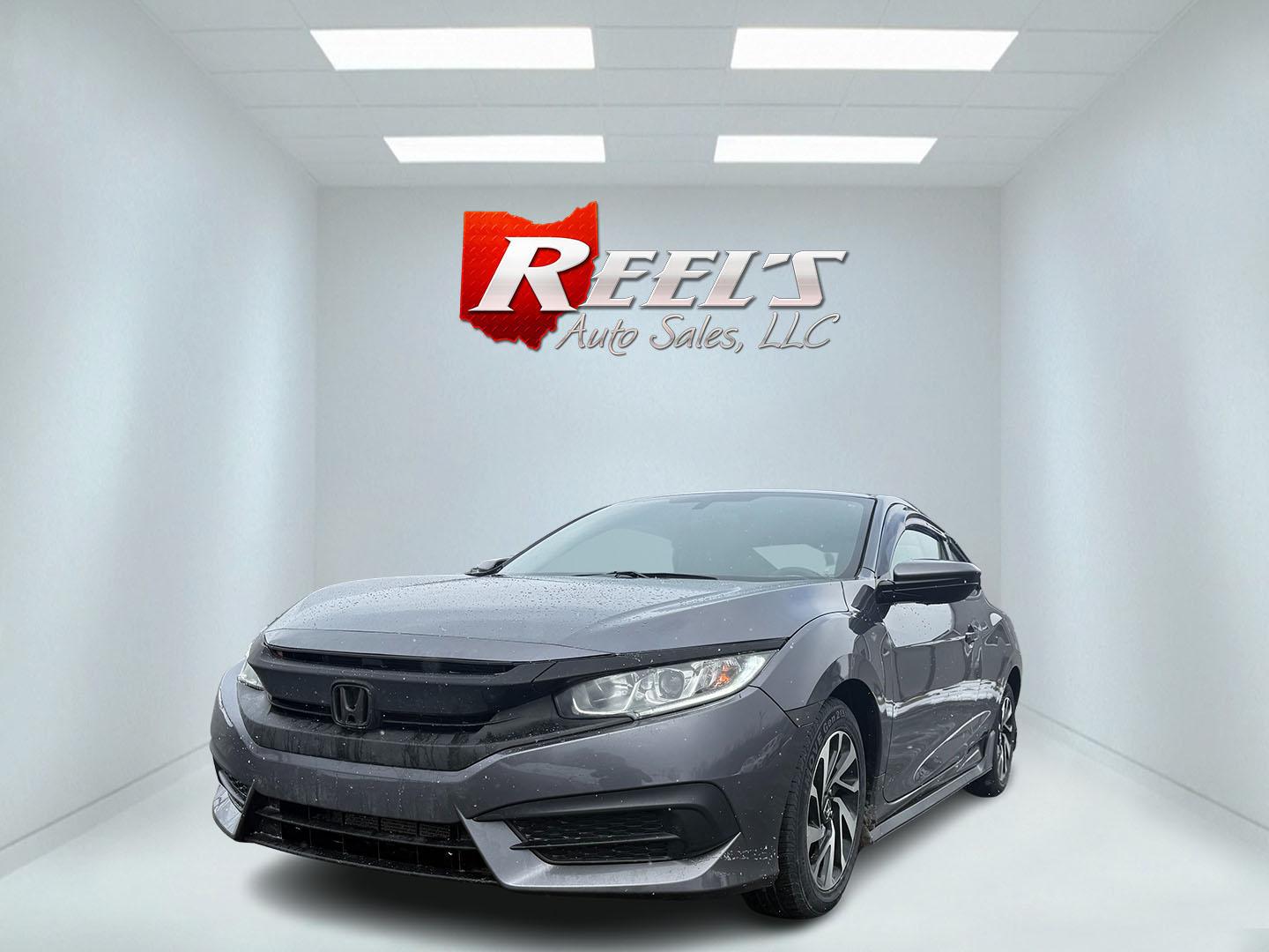 2018 Gray /Black Honda Civic LX Coupe CVT (2HGFC4B51JH) with an 2.0L I4 DOHC 16V engine, Automatic transmission, located at 547 E. Main St., Orwell, OH, 44076, (440) 437-5893, 41.535435, -80.847855 - This 2018 Honda Civic LX Coupe boasts a fuel-efficient 2.0L I4 Earthdreams engine achieving 39 MPG on the highway, and comes well-equipped with modern conveniences like a backup camera and a 5.0-inch center screen, making it a practical and reliable choice. This Honda is fully serviced, comes with a - Photo#0