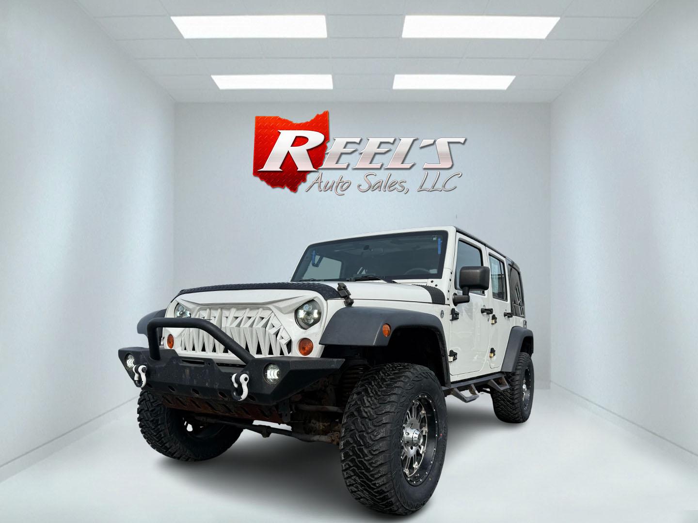 2010 White /Black Jeep Wrangler Unlimited Sport 4WD (1J4BA3H10AL) with an 3.8L V6 OHV 12V engine, 6 Speed Manual transmission, located at 11115 Chardon Rd. , Chardon, OH, 44024, (440) 214-9705, 41.580246, -81.241943 - This 2010 Jeep Wrangler Unlimited Sport with a 3.8 V6 engine and a 6-speed manual transmission is a robust off-road vehicle. Equipped with brand new 33" mud tires and a 4-inch lift kit, this Jeep is well-prepared for rugged terrains and trail adventures. The 3.8-liter V6 engine delivers adequate pow - Photo#0