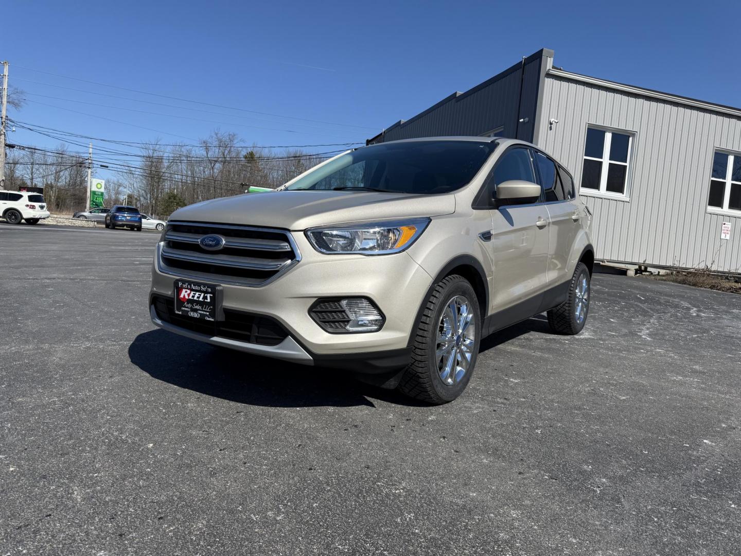 2017 Gold /Black Ford Escape SE 4WD (1FMCU9GD9HU) with an 1.5L I4 DOHC 16V Turbo engine, 6A transmission, located at 11115 Chardon Rd. , Chardon, OH, 44024, (440) 214-9705, 41.580246, -81.241943 - This One Owner 2017 Ford Escape SE 4WD is a versatile compact SUV equipped with a 1.5L I4 EcoBoost engine and a 6-speed automatic transmission, providing an efficient and smooth driving experience with 28 MPG on the highway. It features a power driver's seat for personalized comfort and a backup cam - Photo#0