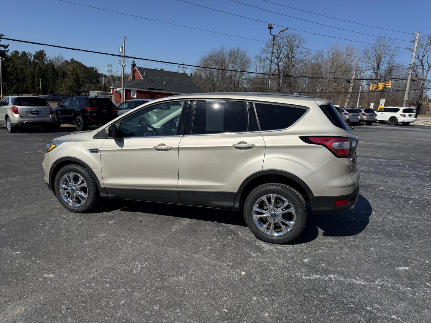 2017 Gold /Black Ford Escape SE 4WD (1FMCU9GD9HU) with an 1.5L I4 DOHC 16V Turbo engine, 6A transmission, located at 11115 Chardon Rd. , Chardon, OH, 44024, (440) 214-9705, 41.580246, -81.241943 - This One Owner 2017 Ford Escape SE 4WD is a versatile compact SUV equipped with a 1.5L I4 EcoBoost engine and a 6-speed automatic transmission, providing an efficient and smooth driving experience with 28 MPG on the highway. It features a power driver's seat for personalized comfort and a backup cam - Photo#10