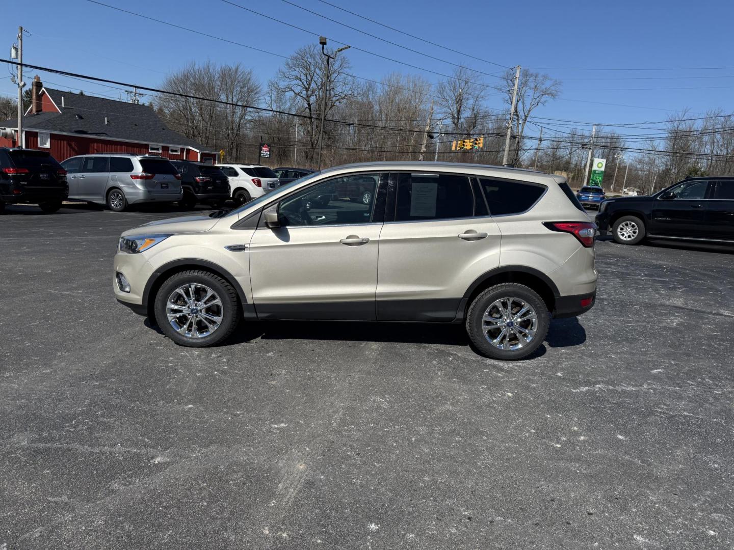 2017 Gold /Black Ford Escape SE 4WD (1FMCU9GD9HU) with an 1.5L I4 DOHC 16V Turbo engine, 6A transmission, located at 11115 Chardon Rd. , Chardon, OH, 44024, (440) 214-9705, 41.580246, -81.241943 - This One Owner 2017 Ford Escape SE 4WD is a versatile compact SUV equipped with a 1.5L I4 EcoBoost engine and a 6-speed automatic transmission, providing an efficient and smooth driving experience with 28 MPG on the highway. It features a power driver's seat for personalized comfort and a backup cam - Photo#12