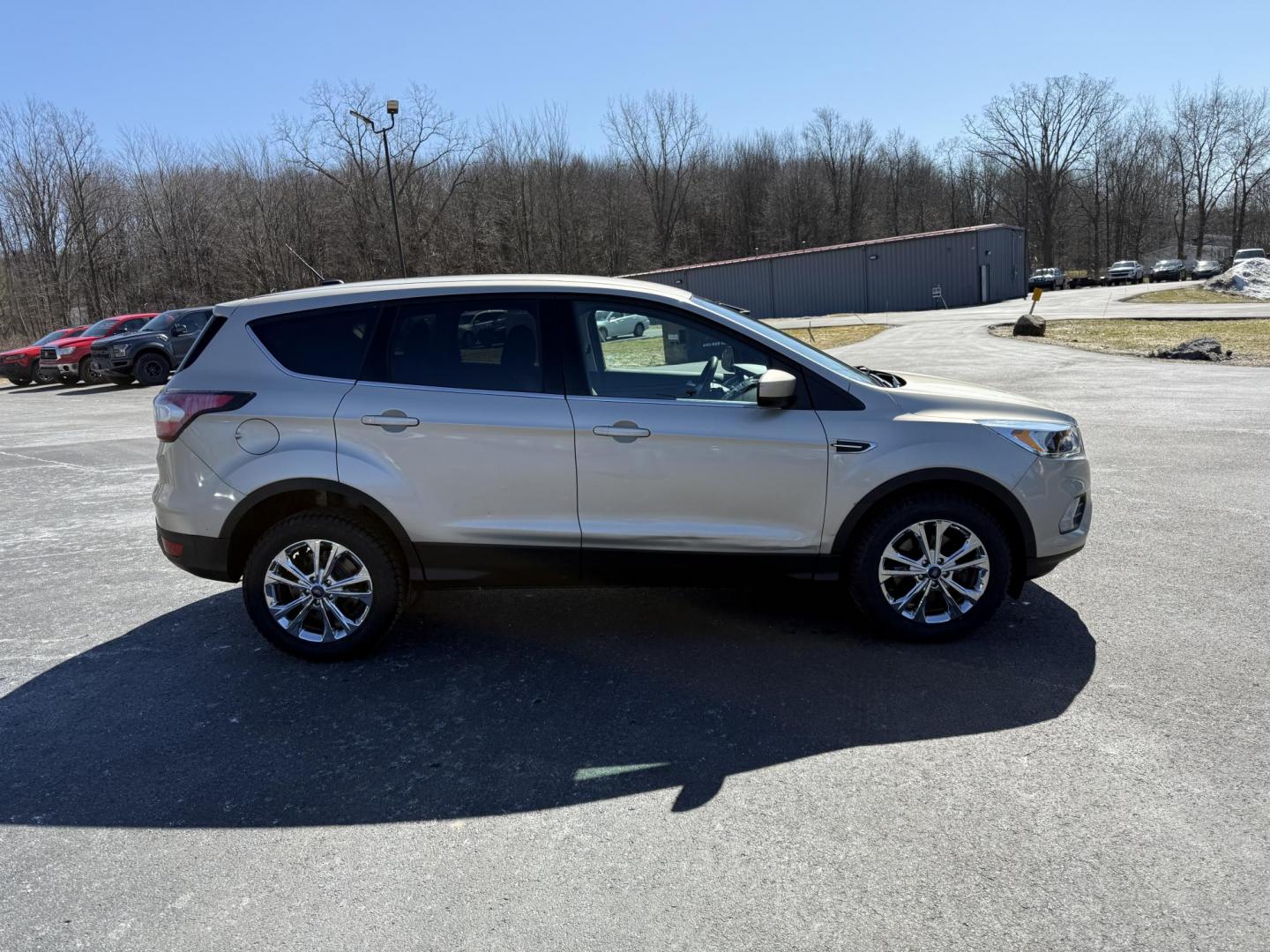 2017 Gold /Black Ford Escape SE 4WD (1FMCU9GD9HU) with an 1.5L I4 DOHC 16V Turbo engine, 6A transmission, located at 11115 Chardon Rd. , Chardon, OH, 44024, (440) 214-9705, 41.580246, -81.241943 - This One Owner 2017 Ford Escape SE 4WD is a versatile compact SUV equipped with a 1.5L I4 EcoBoost engine and a 6-speed automatic transmission, providing an efficient and smooth driving experience with 28 MPG on the highway. It features a power driver's seat for personalized comfort and a backup cam - Photo#5