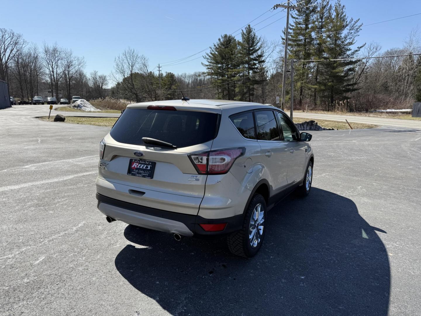 2017 Gold /Black Ford Escape SE 4WD (1FMCU9GD9HU) with an 1.5L I4 DOHC 16V Turbo engine, 6A transmission, located at 11115 Chardon Rd. , Chardon, OH, 44024, (440) 214-9705, 41.580246, -81.241943 - This One Owner 2017 Ford Escape SE 4WD is a versatile compact SUV equipped with a 1.5L I4 EcoBoost engine and a 6-speed automatic transmission, providing an efficient and smooth driving experience with 28 MPG on the highway. It features a power driver's seat for personalized comfort and a backup cam - Photo#7