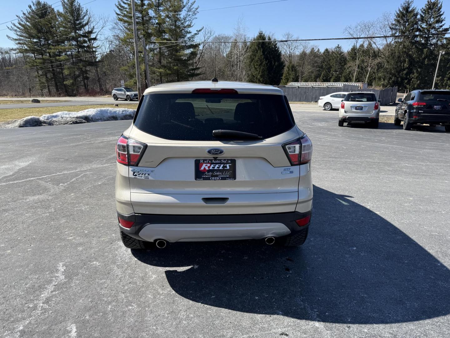 2017 Gold /Black Ford Escape SE 4WD (1FMCU9GD9HU) with an 1.5L I4 DOHC 16V Turbo engine, 6A transmission, located at 11115 Chardon Rd. , Chardon, OH, 44024, (440) 214-9705, 41.580246, -81.241943 - This One Owner 2017 Ford Escape SE 4WD is a versatile compact SUV equipped with a 1.5L I4 EcoBoost engine and a 6-speed automatic transmission, providing an efficient and smooth driving experience with 28 MPG on the highway. It features a power driver's seat for personalized comfort and a backup cam - Photo#8