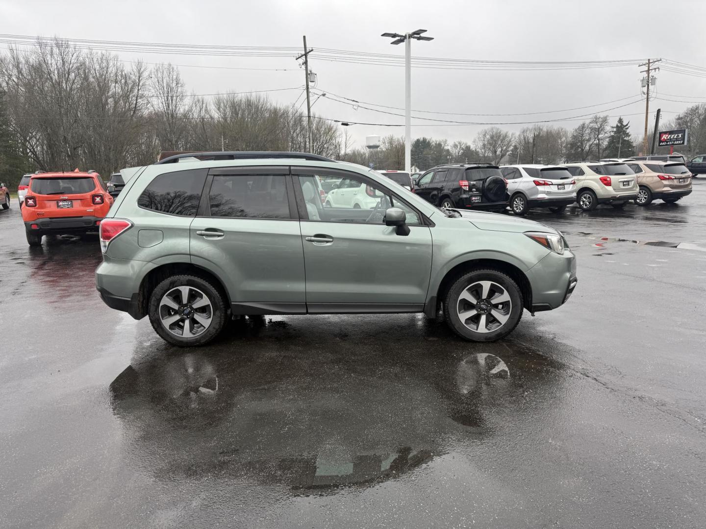 2017 Green /Gray Subaru Forester 2.5i Premium PZEV CVT (JF2SJAEC3HH) with an 2.5L H4 DOHC 16V engine, Automatic transmission, located at 547 E. Main St., Orwell, OH, 44076, (440) 437-5893, 41.535435, -80.847855 - This One Owner Subaru Forester is super fuel efficient and capable. With a 2.5-liter H4 engine and Subaru's Symmetrical All-Wheel Drive system, offering stability and traction. It features comforts like heated front seats, a 7.0-inch touchscreen for infotainment, and single-zone automatic climate co - Photo#5