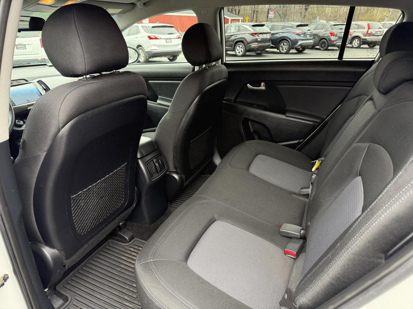 2015 White /Black Kia Sportage LX AWD (KNDPBCAC2F7) with an 2.4L I4 DOHC 16V engine, 6-Speed Automatic transmission, located at 11115 Chardon Rd. , Chardon, OH, 44024, (440) 214-9705, 41.580246, -81.241943 - This One Owner 2015 Kia Sportage LX AWD is a compact SUV equipped with a 2.4-liter inline-four GDI engine paired with a 6-speed automatic transmission. Despite being from 2015, this model offers modern amenities such as ECO driving mode for enhanced fuel efficiency and compatibility with Apple Carpl - Photo#21