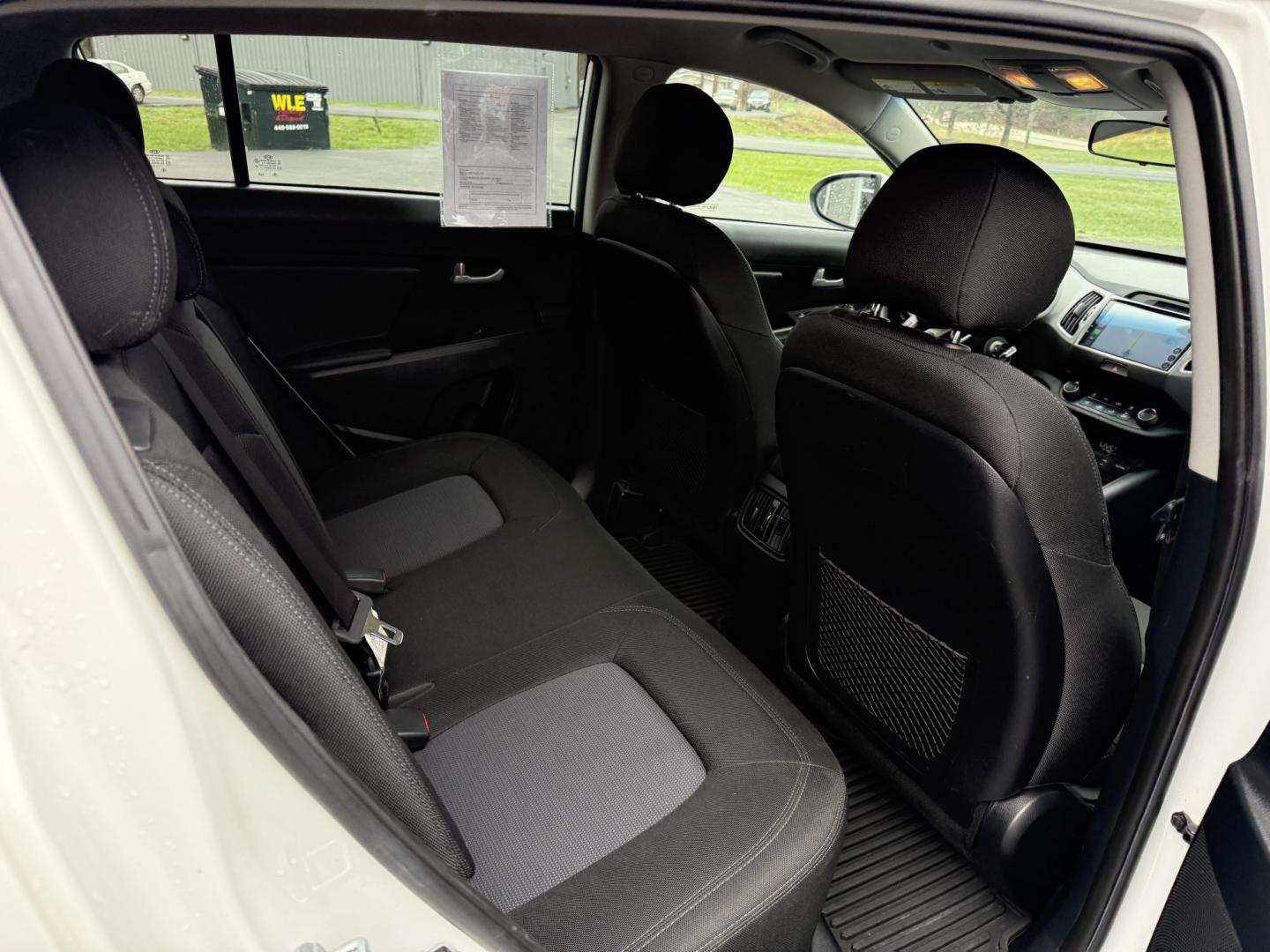 2015 White /Black Kia Sportage LX AWD (KNDPBCAC2F7) with an 2.4L I4 DOHC 16V engine, 6-Speed Automatic transmission, located at 11115 Chardon Rd. , Chardon, OH, 44024, (440) 214-9705, 41.580246, -81.241943 - This One Owner 2015 Kia Sportage LX AWD is a compact SUV equipped with a 2.4-liter inline-four GDI engine paired with a 6-speed automatic transmission. Despite being from 2015, this model offers modern amenities such as ECO driving mode for enhanced fuel efficiency and compatibility with Apple Carpl - Photo#26