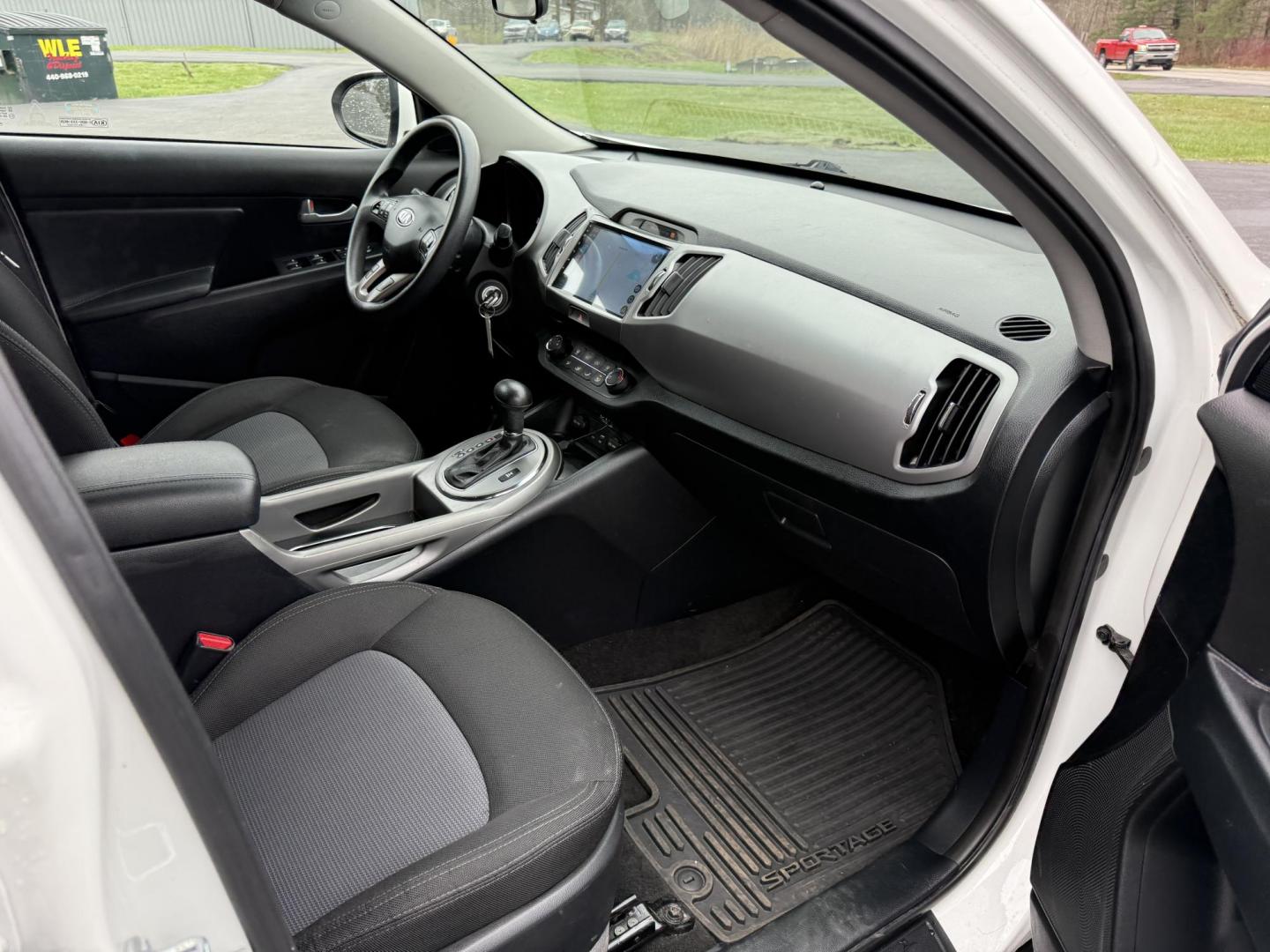 2015 White /Black Kia Sportage LX AWD (KNDPBCAC2F7) with an 2.4L I4 DOHC 16V engine, 6-Speed Automatic transmission, located at 11115 Chardon Rd. , Chardon, OH, 44024, (440) 214-9705, 41.580246, -81.241943 - This One Owner 2015 Kia Sportage LX AWD is a compact SUV equipped with a 2.4-liter inline-four GDI engine paired with a 6-speed automatic transmission. Despite being from 2015, this model offers modern amenities such as ECO driving mode for enhanced fuel efficiency and compatibility with Apple Carpl - Photo#29