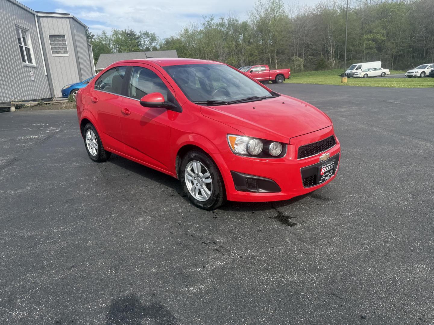 2015 Red /Black Chevrolet Sonic LT Auto Sedan (1G1JC5SH8F4) with an 1.8L I4 DOHC 24V engine, 6-Speed Automatic transmission, located at 11115 Chardon Rd. , Chardon, OH, 44024, (440) 214-9705, 41.580246, -81.241943 - FRESH TRADE IN ALERT ---- This 2015 Chevrolet Sonic LT Sedan with a 1.8L I4 EcoTec engine and 6-speed automatic transmission offers a blend of efficiency and convenience, achieving up to 34 MPG on the highway. Standard features include daytime running lights, dusk-sensing headlights for enhanced sa - Photo#2