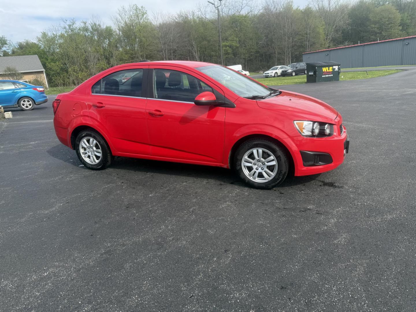 2015 Red /Black Chevrolet Sonic LT Auto Sedan (1G1JC5SH8F4) with an 1.8L I4 DOHC 24V engine, 6-Speed Automatic transmission, located at 11115 Chardon Rd. , Chardon, OH, 44024, (440) 214-9705, 41.580246, -81.241943 - FRESH TRADE IN ALERT ---- This 2015 Chevrolet Sonic LT Sedan with a 1.8L I4 EcoTec engine and 6-speed automatic transmission offers a blend of efficiency and convenience, achieving up to 34 MPG on the highway. Standard features include daytime running lights, dusk-sensing headlights for enhanced sa - Photo#3