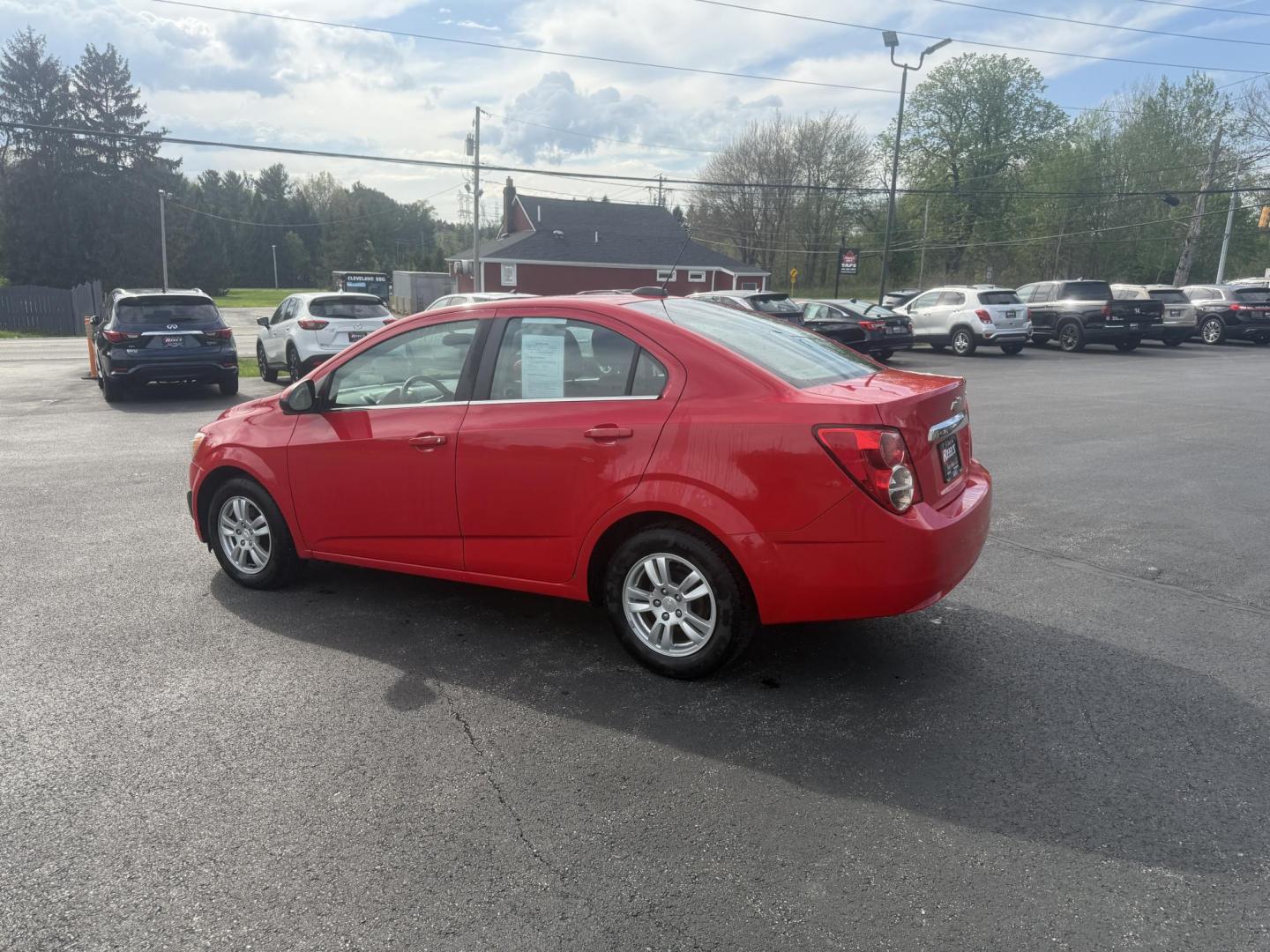 2015 Red /Black Chevrolet Sonic LT Auto Sedan (1G1JC5SH8F4) with an 1.8L I4 DOHC 24V engine, 6-Speed Automatic transmission, located at 11115 Chardon Rd. , Chardon, OH, 44024, (440) 214-9705, 41.580246, -81.241943 - FRESH TRADE IN ALERT ---- This 2015 Chevrolet Sonic LT Sedan with a 1.8L I4 EcoTec engine and 6-speed automatic transmission offers a blend of efficiency and convenience, achieving up to 34 MPG on the highway. Standard features include daytime running lights, dusk-sensing headlights for enhanced sa - Photo#10