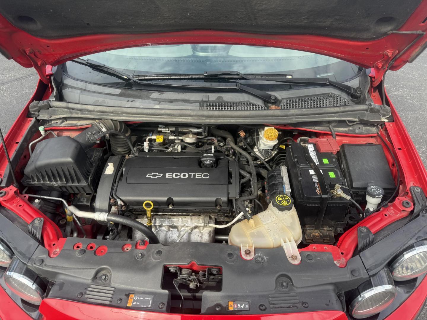 2015 Red /Black Chevrolet Sonic LT Auto Sedan (1G1JC5SH8F4) with an 1.8L I4 DOHC 24V engine, 6-Speed Automatic transmission, located at 11115 Chardon Rd. , Chardon, OH, 44024, (440) 214-9705, 41.580246, -81.241943 - FRESH TRADE IN ALERT ---- This 2015 Chevrolet Sonic LT Sedan with a 1.8L I4 EcoTec engine and 6-speed automatic transmission offers a blend of efficiency and convenience, achieving up to 34 MPG on the highway. Standard features include daytime running lights, dusk-sensing headlights for enhanced sa - Photo#14