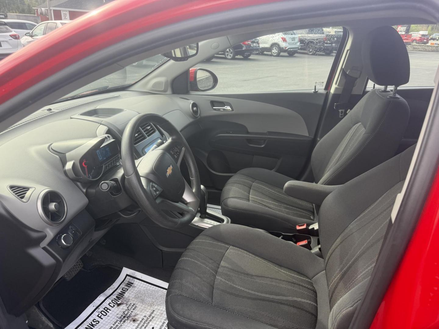 2015 Red /Black Chevrolet Sonic LT Auto Sedan (1G1JC5SH8F4) with an 1.8L I4 DOHC 24V engine, 6-Speed Automatic transmission, located at 11115 Chardon Rd. , Chardon, OH, 44024, (440) 214-9705, 41.580246, -81.241943 - FRESH TRADE IN ALERT ---- This 2015 Chevrolet Sonic LT Sedan with a 1.8L I4 EcoTec engine and 6-speed automatic transmission offers a blend of efficiency and convenience, achieving up to 34 MPG on the highway. Standard features include daytime running lights, dusk-sensing headlights for enhanced sa - Photo#15