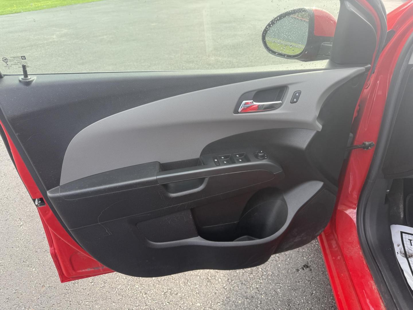 2015 Red /Black Chevrolet Sonic LT Auto Sedan (1G1JC5SH8F4) with an 1.8L I4 DOHC 24V engine, 6-Speed Automatic transmission, located at 11115 Chardon Rd. , Chardon, OH, 44024, (440) 214-9705, 41.580246, -81.241943 - FRESH TRADE IN ALERT ---- This 2015 Chevrolet Sonic LT Sedan with a 1.8L I4 EcoTec engine and 6-speed automatic transmission offers a blend of efficiency and convenience, achieving up to 34 MPG on the highway. Standard features include daytime running lights, dusk-sensing headlights for enhanced sa - Photo#16