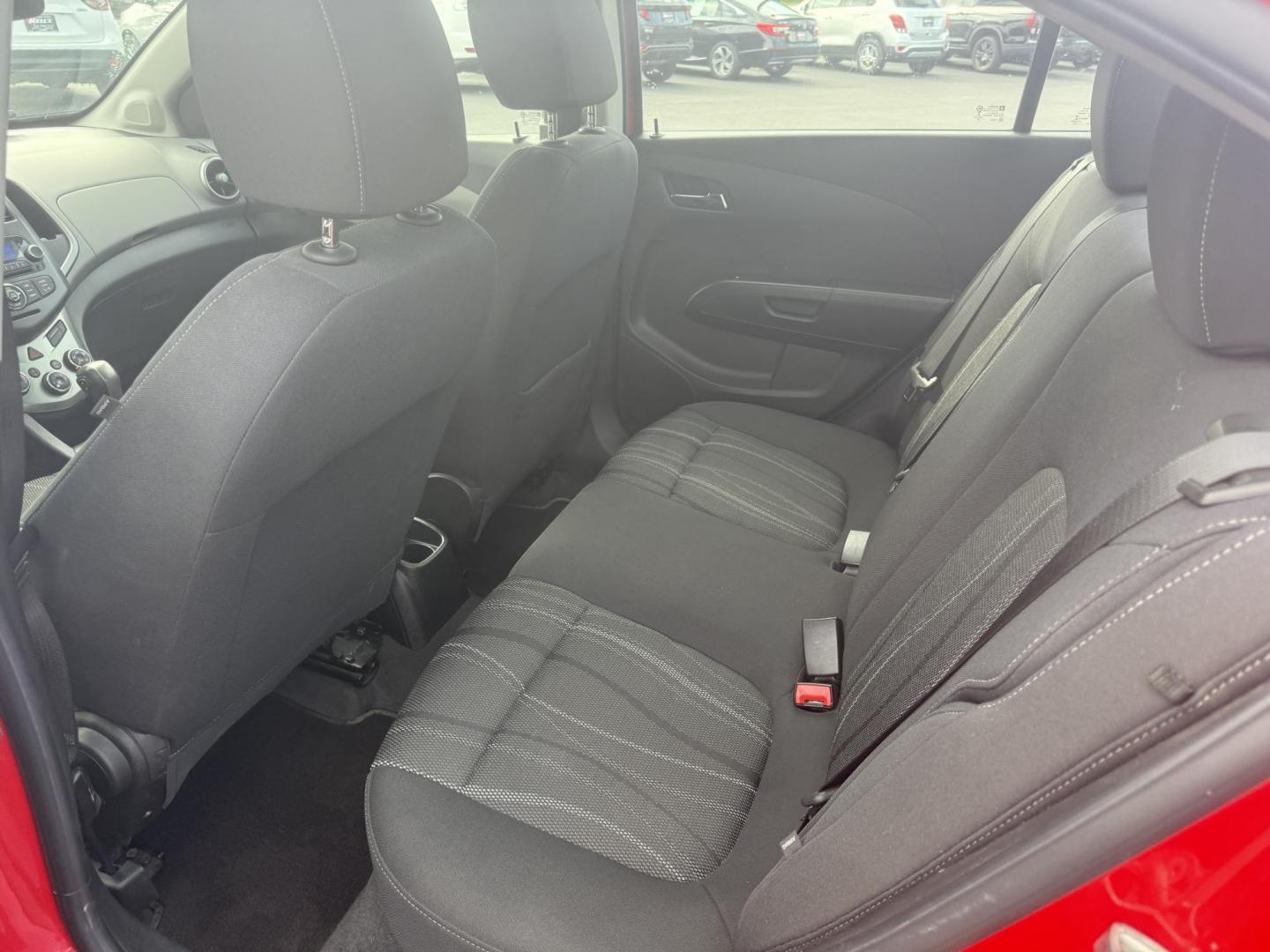 2015 Red /Black Chevrolet Sonic LT Auto Sedan (1G1JC5SH8F4) with an 1.8L I4 DOHC 24V engine, 6-Speed Automatic transmission, located at 11115 Chardon Rd. , Chardon, OH, 44024, (440) 214-9705, 41.580246, -81.241943 - FRESH TRADE IN ALERT ---- This 2015 Chevrolet Sonic LT Sedan with a 1.8L I4 EcoTec engine and 6-speed automatic transmission offers a blend of efficiency and convenience, achieving up to 34 MPG on the highway. Standard features include daytime running lights, dusk-sensing headlights for enhanced sa - Photo#26