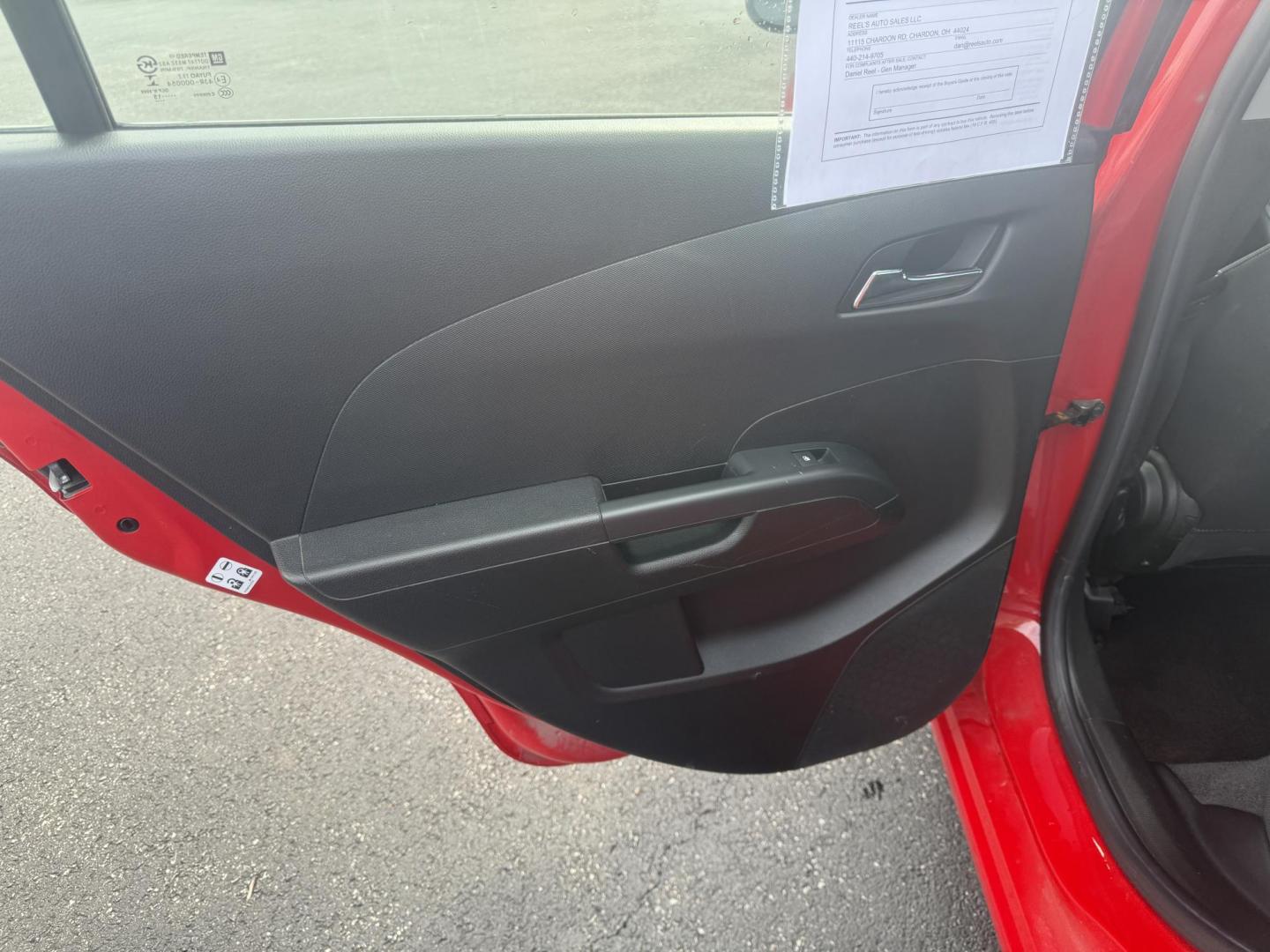 2015 Red /Black Chevrolet Sonic LT Auto Sedan (1G1JC5SH8F4) with an 1.8L I4 DOHC 24V engine, 6-Speed Automatic transmission, located at 11115 Chardon Rd. , Chardon, OH, 44024, (440) 214-9705, 41.580246, -81.241943 - FRESH TRADE IN ALERT ---- This 2015 Chevrolet Sonic LT Sedan with a 1.8L I4 EcoTec engine and 6-speed automatic transmission offers a blend of efficiency and convenience, achieving up to 34 MPG on the highway. Standard features include daytime running lights, dusk-sensing headlights for enhanced sa - Photo#27