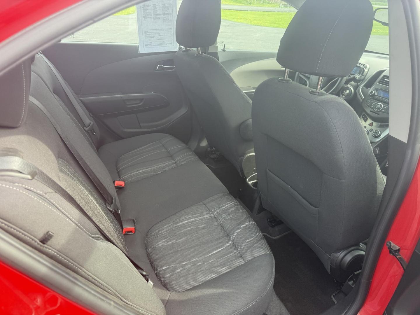 2015 Red /Black Chevrolet Sonic LT Auto Sedan (1G1JC5SH8F4) with an 1.8L I4 DOHC 24V engine, 6-Speed Automatic transmission, located at 11115 Chardon Rd. , Chardon, OH, 44024, (440) 214-9705, 41.580246, -81.241943 - FRESH TRADE IN ALERT ---- This 2015 Chevrolet Sonic LT Sedan with a 1.8L I4 EcoTec engine and 6-speed automatic transmission offers a blend of efficiency and convenience, achieving up to 34 MPG on the highway. Standard features include daytime running lights, dusk-sensing headlights for enhanced sa - Photo#32