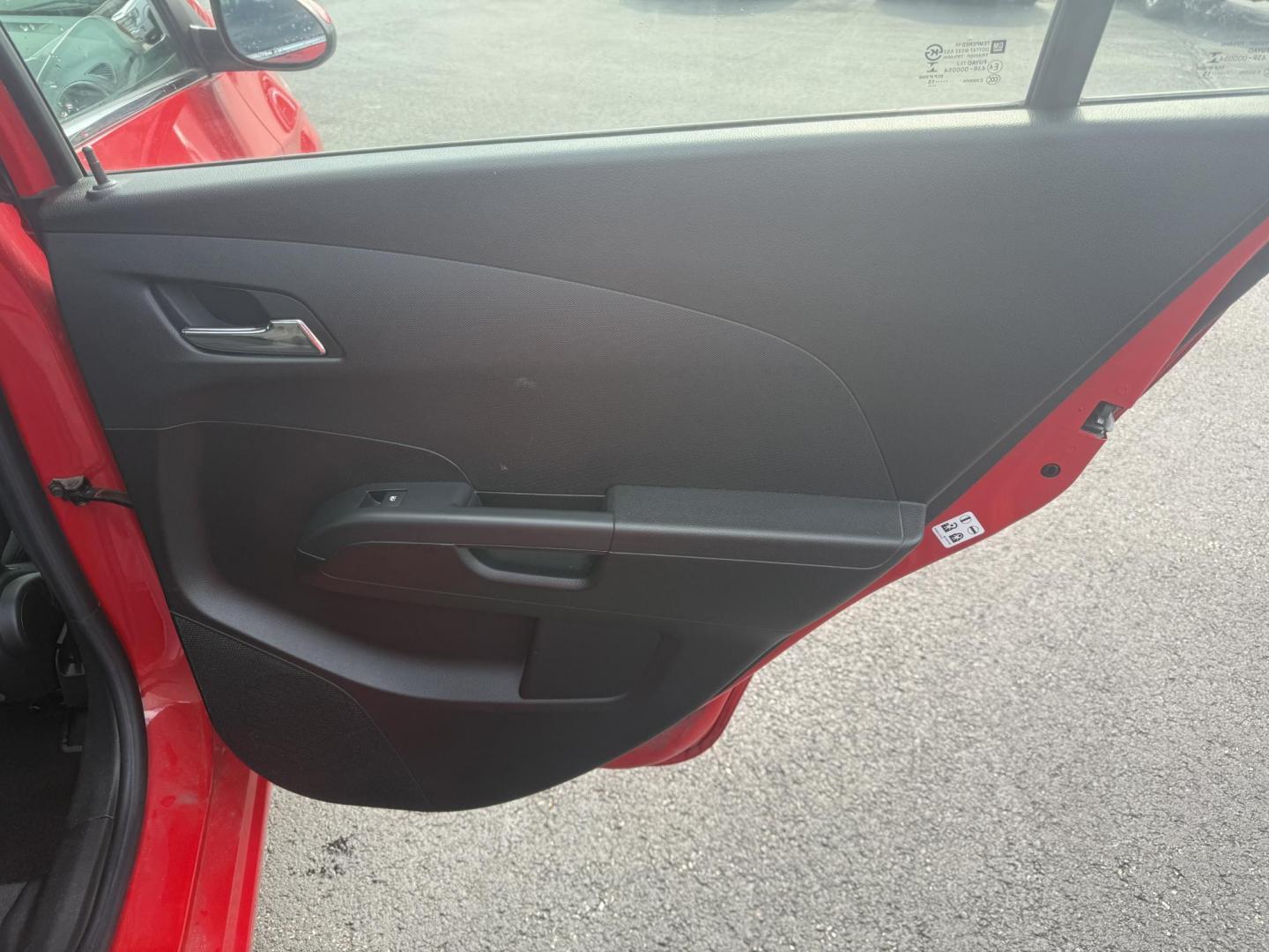 2015 Red /Black Chevrolet Sonic LT Auto Sedan (1G1JC5SH8F4) with an 1.8L I4 DOHC 24V engine, 6-Speed Automatic transmission, located at 11115 Chardon Rd. , Chardon, OH, 44024, (440) 214-9705, 41.580246, -81.241943 - FRESH TRADE IN ALERT ---- This 2015 Chevrolet Sonic LT Sedan with a 1.8L I4 EcoTec engine and 6-speed automatic transmission offers a blend of efficiency and convenience, achieving up to 34 MPG on the highway. Standard features include daytime running lights, dusk-sensing headlights for enhanced sa - Photo#33