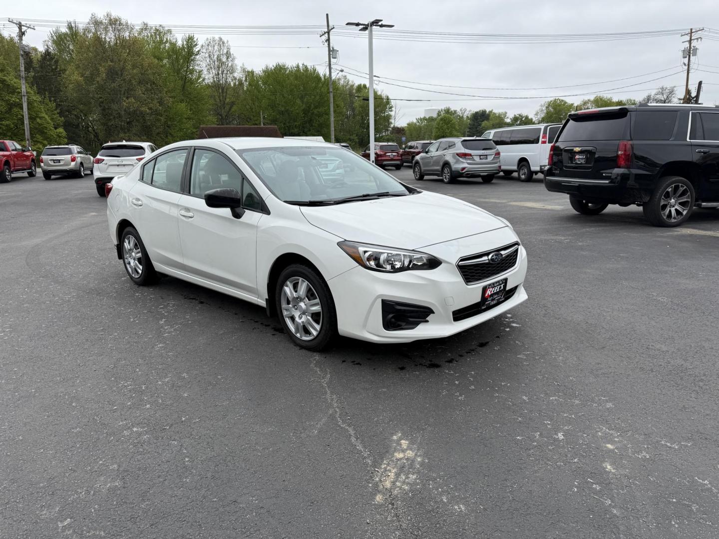 2017 White /Gray Subaru Impreza 2.0i 4-Door (4S3GKAA60H3) with an 2.0L H4 DOHC 16V engine, Automatic transmission, located at 547 E. Main St., Orwell, OH, 44076, (440) 437-5893, 41.535435, -80.847855 - This little 2017 Subaru Imprezza is a modern and fuel efficient sedan. Equipped with a 2.0-liter H4 engine and Subaru’s Symmetrical All-Wheel Drive system, offering confident handling and stability. It boasts impressive fuel efficiency, achieving up to 38 MPG on the highway. Standard features incl - Photo#2