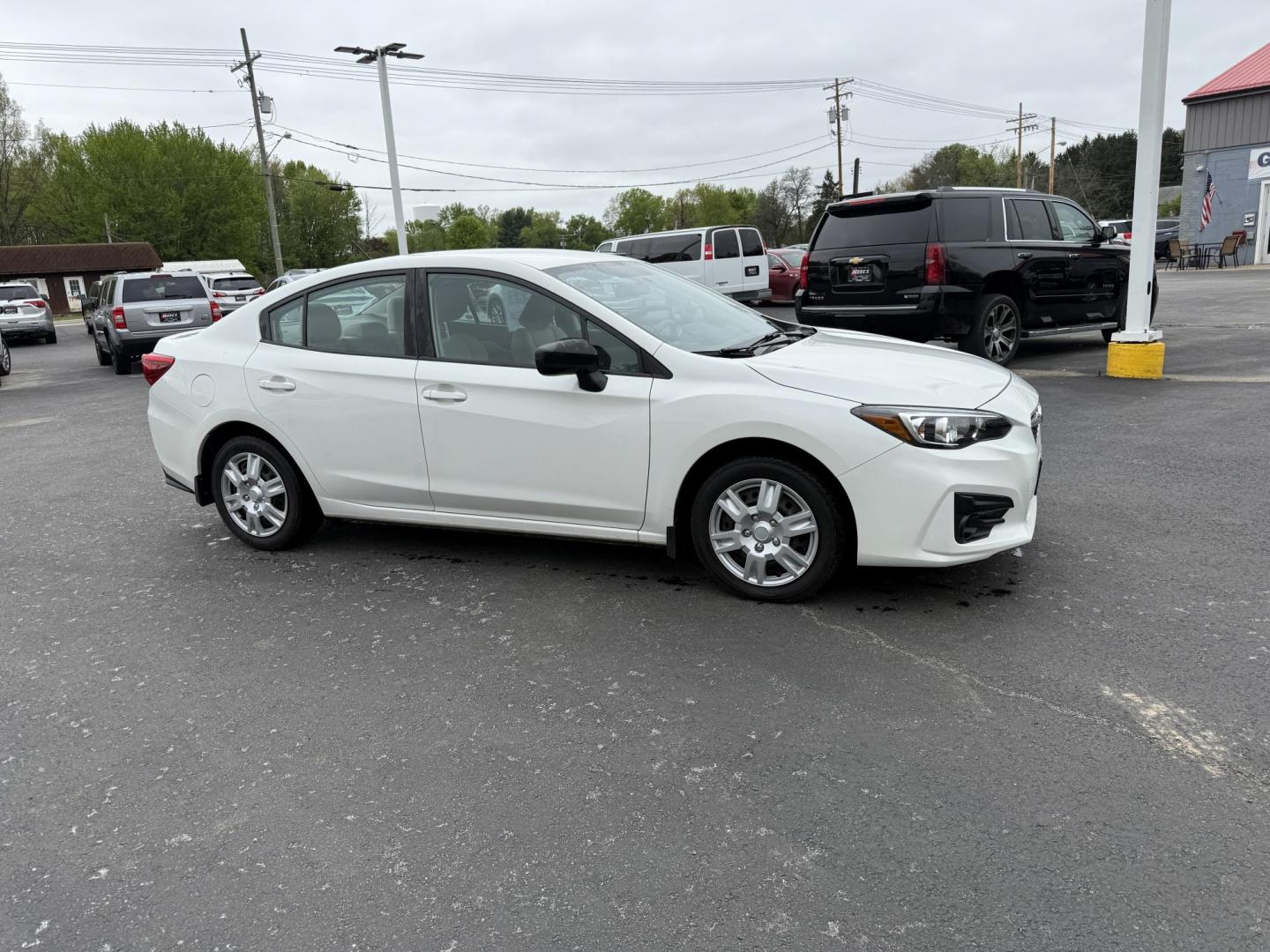 2017 White /Gray Subaru Impreza 2.0i 4-Door (4S3GKAA60H3) with an 2.0L H4 DOHC 16V engine, Automatic transmission, located at 547 E. Main St., Orwell, OH, 44076, (440) 437-5893, 41.535435, -80.847855 - This little 2017 Subaru Imprezza is a modern and fuel efficient sedan. Equipped with a 2.0-liter H4 engine and Subaru’s Symmetrical All-Wheel Drive system, offering confident handling and stability. It boasts impressive fuel efficiency, achieving up to 38 MPG on the highway. Standard features incl - Photo#3
