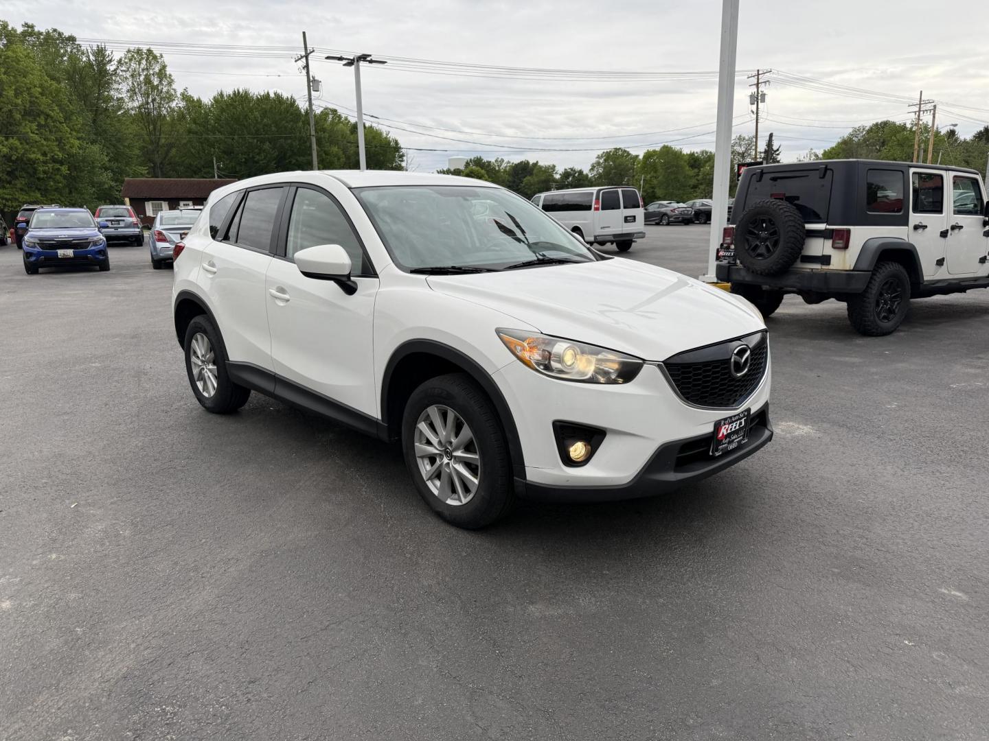 2014 White /Black Mazda CX-5 Touring AWD (JM3KE4CY7E0) with an 2.5L I4 DOHC 16V engine, 6-Speed Automatic transmission, located at 547 E. Main St., Orwell, OH, 44076, (440) 437-5893, 41.535435, -80.847855 - This 2014 Mazda CX-5 Touring features a 2.5L inline-4 engine paired with a 6-speed automatic transmission, offering a balanced blend of performance and efficiency with an estimated 29 MPG on the highway. It comes well-equipped for its class, including a 6.5-inch touchscreen, backup camera, blind spo - Photo#2