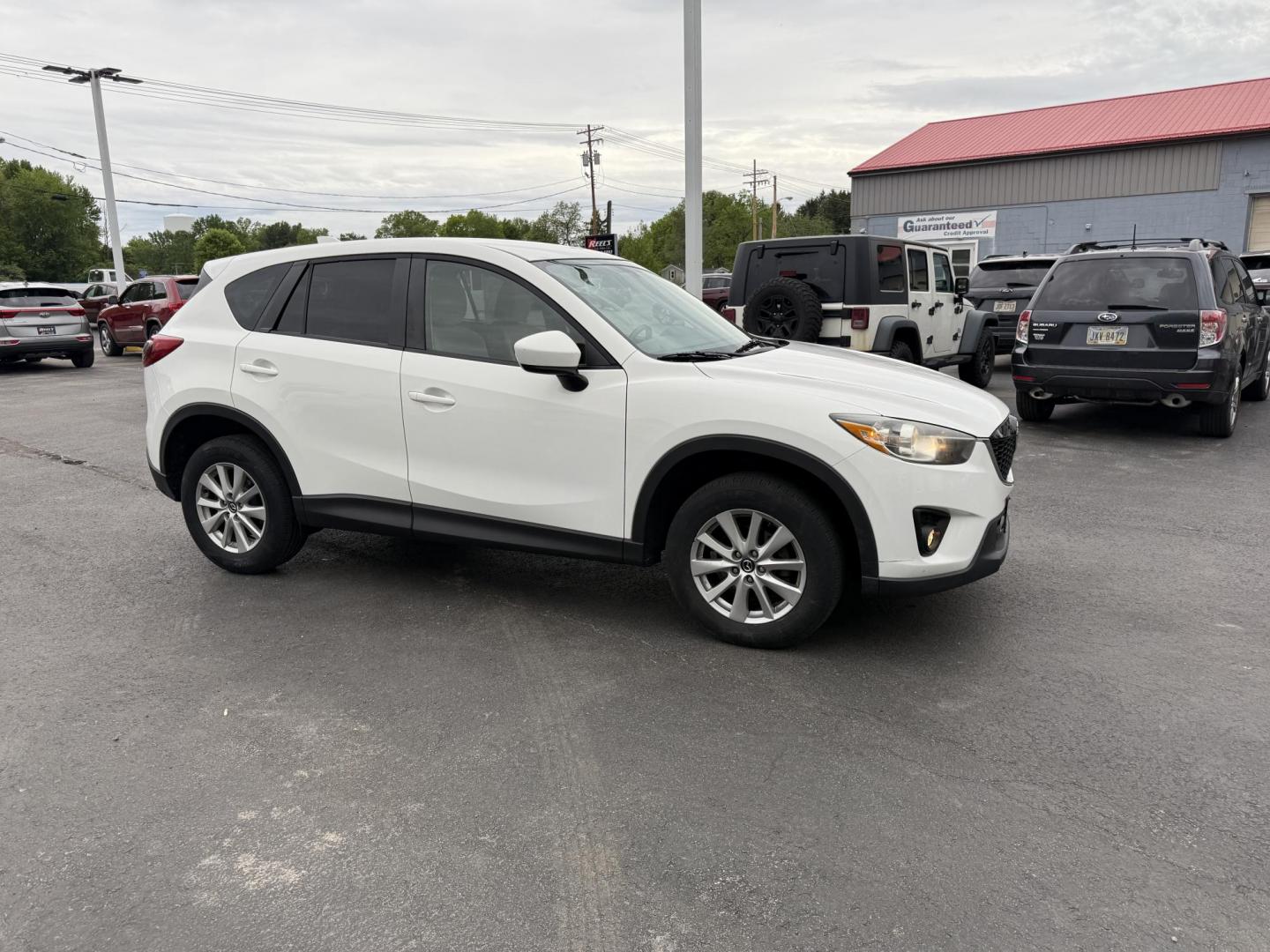 2014 White /Black Mazda CX-5 Touring AWD (JM3KE4CY7E0) with an 2.5L I4 DOHC 16V engine, 6-Speed Automatic transmission, located at 547 E. Main St., Orwell, OH, 44076, (440) 437-5893, 41.535435, -80.847855 - This 2014 Mazda CX-5 Touring features a 2.5L inline-4 engine paired with a 6-speed automatic transmission, offering a balanced blend of performance and efficiency with an estimated 29 MPG on the highway. It comes well-equipped for its class, including a 6.5-inch touchscreen, backup camera, blind spo - Photo#3