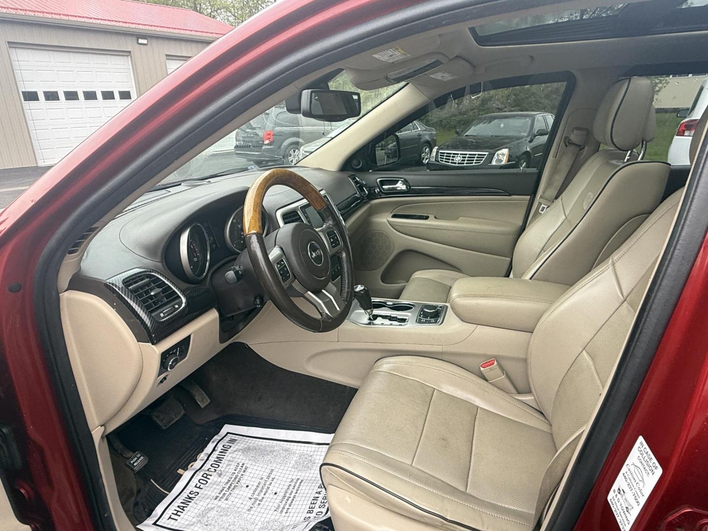 2011 Red /Tan Jeep Grand Cherokee Overland 4WD (1J4RR6GT8BC) with an 5.7L V8 OHV 16V engine, 5-Speed Automatic transmission, located at 547 E. Main St., Orwell, OH, 44076, (440) 437-5893, 41.535435, -80.847855 - This 2011 Jeep Grand Cherokee Overland 4WD comes equipped with a powerful 5.7L HEMI V8 engine and a 5-speed automatic transmission, offering robust performance and a substantial 7,200-pound towing capacity. Its luxury-oriented interior features leather seating, heated and cooled front seats, a 6.5-i - Photo#4