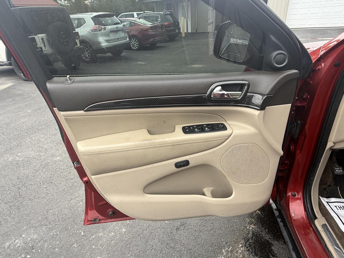 2011 Red /Tan Jeep Grand Cherokee Overland 4WD (1J4RR6GT8BC) with an 5.7L V8 OHV 16V engine, 5-Speed Automatic transmission, located at 547 E. Main St., Orwell, OH, 44076, (440) 437-5893, 41.535435, -80.847855 - This 2011 Jeep Grand Cherokee Overland 4WD comes equipped with a powerful 5.7L HEMI V8 engine and a 5-speed automatic transmission, offering robust performance and a substantial 7,200-pound towing capacity. Its luxury-oriented interior features leather seating, heated and cooled front seats, a 6.5-i - Photo#3