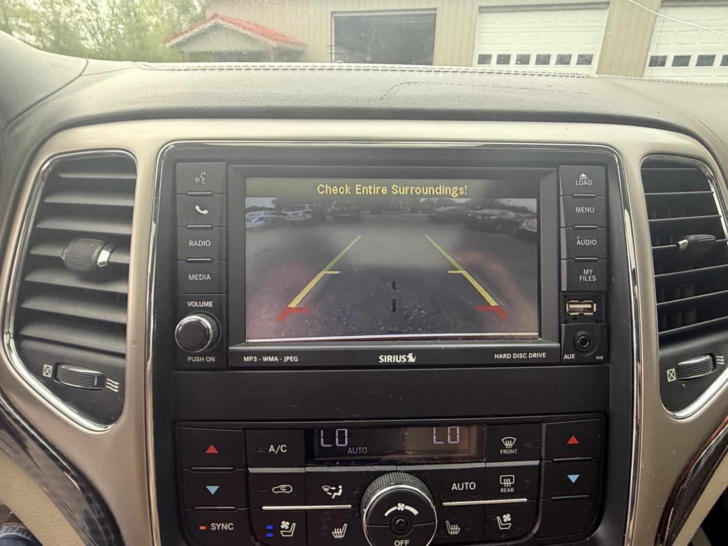 2011 Red /Tan Jeep Grand Cherokee Overland 4WD (1J4RR6GT8BC) with an 5.7L V8 OHV 16V engine, 5-Speed Automatic transmission, located at 547 E. Main St., Orwell, OH, 44076, (440) 437-5893, 41.535435, -80.847855 - This 2011 Jeep Grand Cherokee Overland 4WD comes equipped with a powerful 5.7L HEMI V8 engine and a 5-speed automatic transmission, offering robust performance and a substantial 7,200-pound towing capacity. Its luxury-oriented interior features leather seating, heated and cooled front seats, a 6.5-i - Photo#22