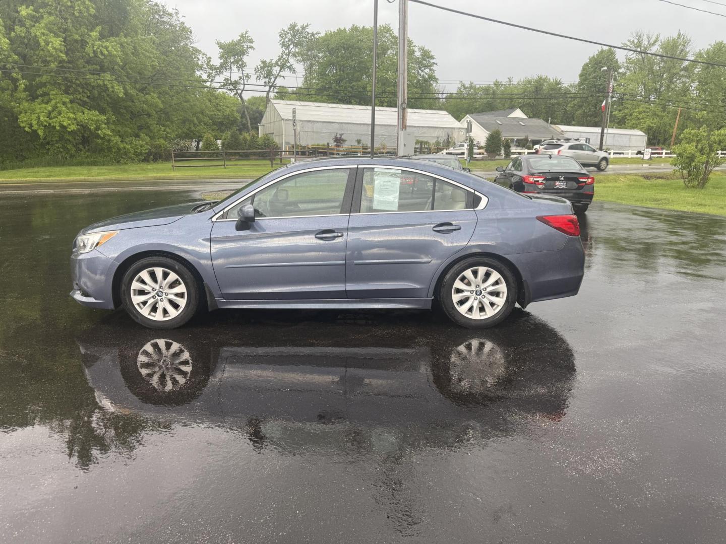 2015 Blue /Tan Subaru Legacy 2.5i Premium (4S3BNAC69F3) with an 2.5L H4 DOHC 16V engine, Automatic transmission, located at 11115 Chardon Rd. , Chardon, OH, 44024, (440) 214-9705, 41.580246, -81.241943 - This 2015 Subaru Legacy 2.5i Premium is equipped with a 2.5L H4 engine and Subaru's renowned Symmetrical All-Wheel Drive, delivering excellent traction and up to 35 MPG highway. This midsize sedan offers comfort and convenience with dual-zone automatic climate control, heated front seats, a power dr - Photo#12