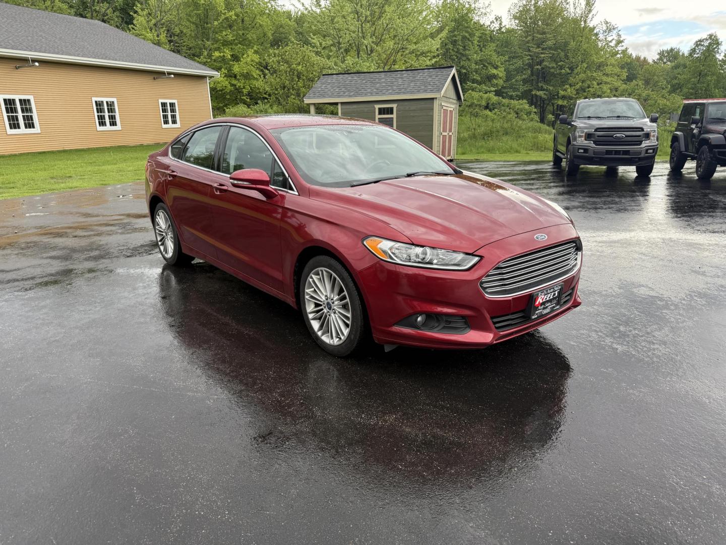 2016 Red /Black Ford Fusion SE AWD (3FA6P0T9XGR) with an 2.0L I4 DOHC 16V Turbo engine, 6A transmission, located at 11115 Chardon Rd. , Chardon, OH, 44024, (440) 214-9705, 41.580246, -81.241943 - This One Owner 2016 Ford Fusion SE AWD features a 2.0L turbocharged I4 engine paired with a 6-speed automatic transmission, offering a quick and fuel-efficient drive with up to 31 MPG highway. It boasts leather interior, heated power driver's seat, dual-zone automatic climate control, power moonroof - Photo#2