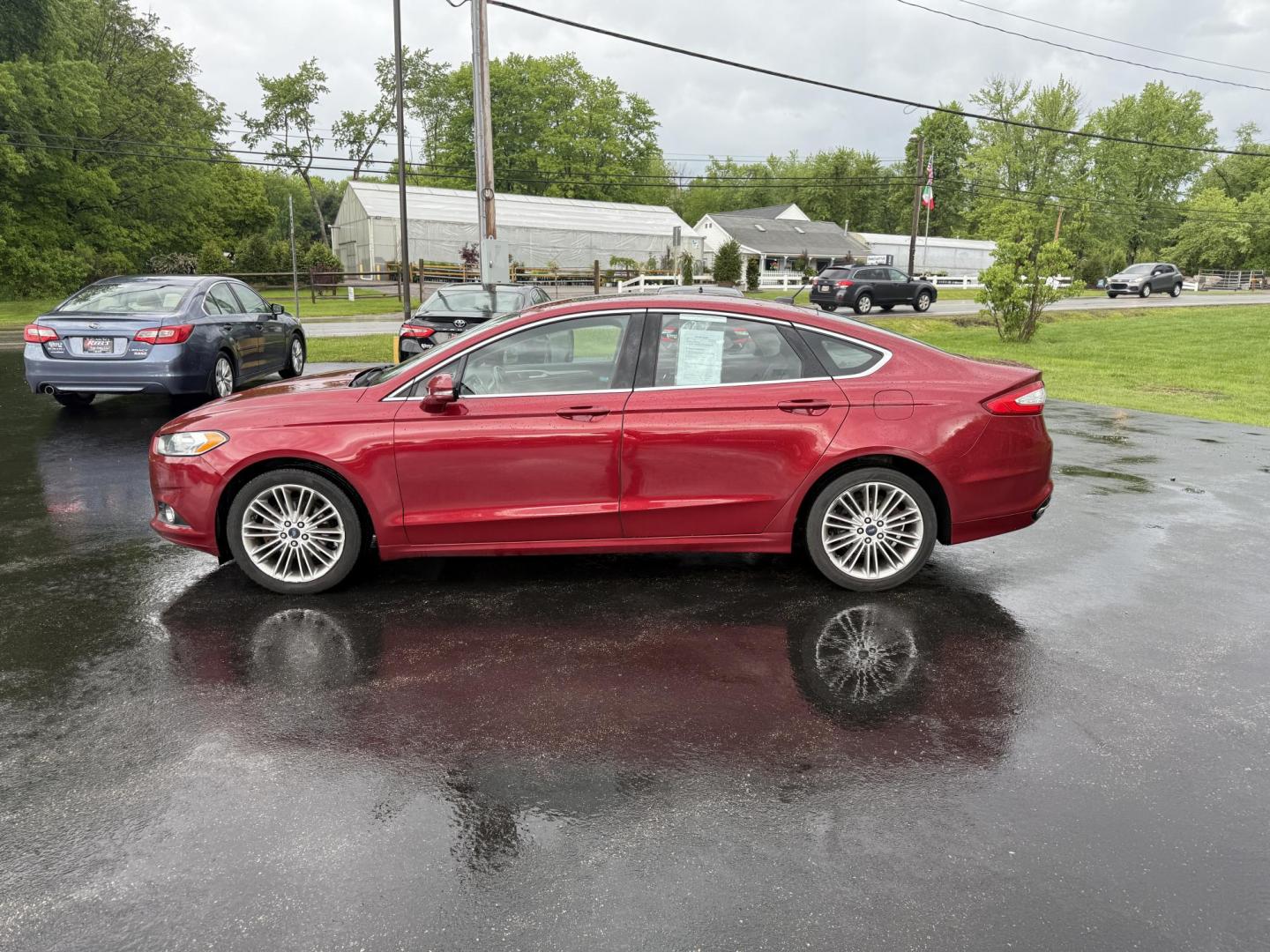 2016 Red /Black Ford Fusion SE AWD (3FA6P0T9XGR) with an 2.0L I4 DOHC 16V Turbo engine, 6A transmission, located at 11115 Chardon Rd. , Chardon, OH, 44024, (440) 214-9705, 41.580246, -81.241943 - This One Owner 2016 Ford Fusion SE AWD features a 2.0L turbocharged I4 engine paired with a 6-speed automatic transmission, offering a quick and fuel-efficient drive with up to 31 MPG highway. It boasts leather interior, heated power driver's seat, dual-zone automatic climate control, power moonroof - Photo#12