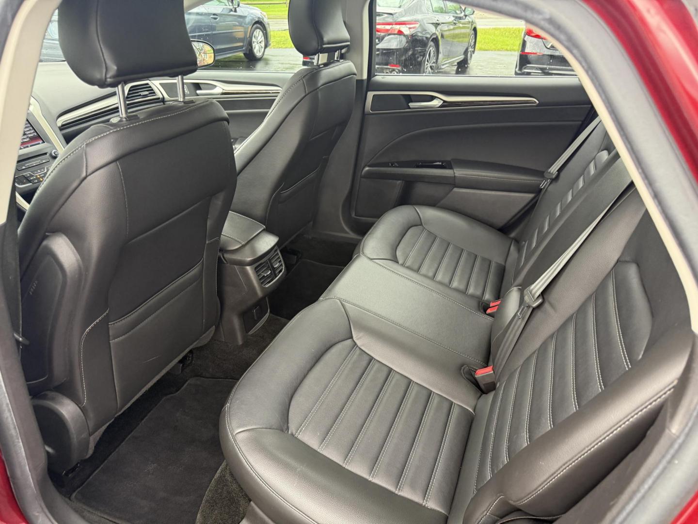 2016 Red /Black Ford Fusion SE AWD (3FA6P0T9XGR) with an 2.0L I4 DOHC 16V Turbo engine, 6A transmission, located at 11115 Chardon Rd. , Chardon, OH, 44024, (440) 214-9705, 41.580246, -81.241943 - This One Owner 2016 Ford Fusion SE AWD features a 2.0L turbocharged I4 engine paired with a 6-speed automatic transmission, offering a quick and fuel-efficient drive with up to 31 MPG highway. It boasts leather interior, heated power driver's seat, dual-zone automatic climate control, power moonroof - Photo#35